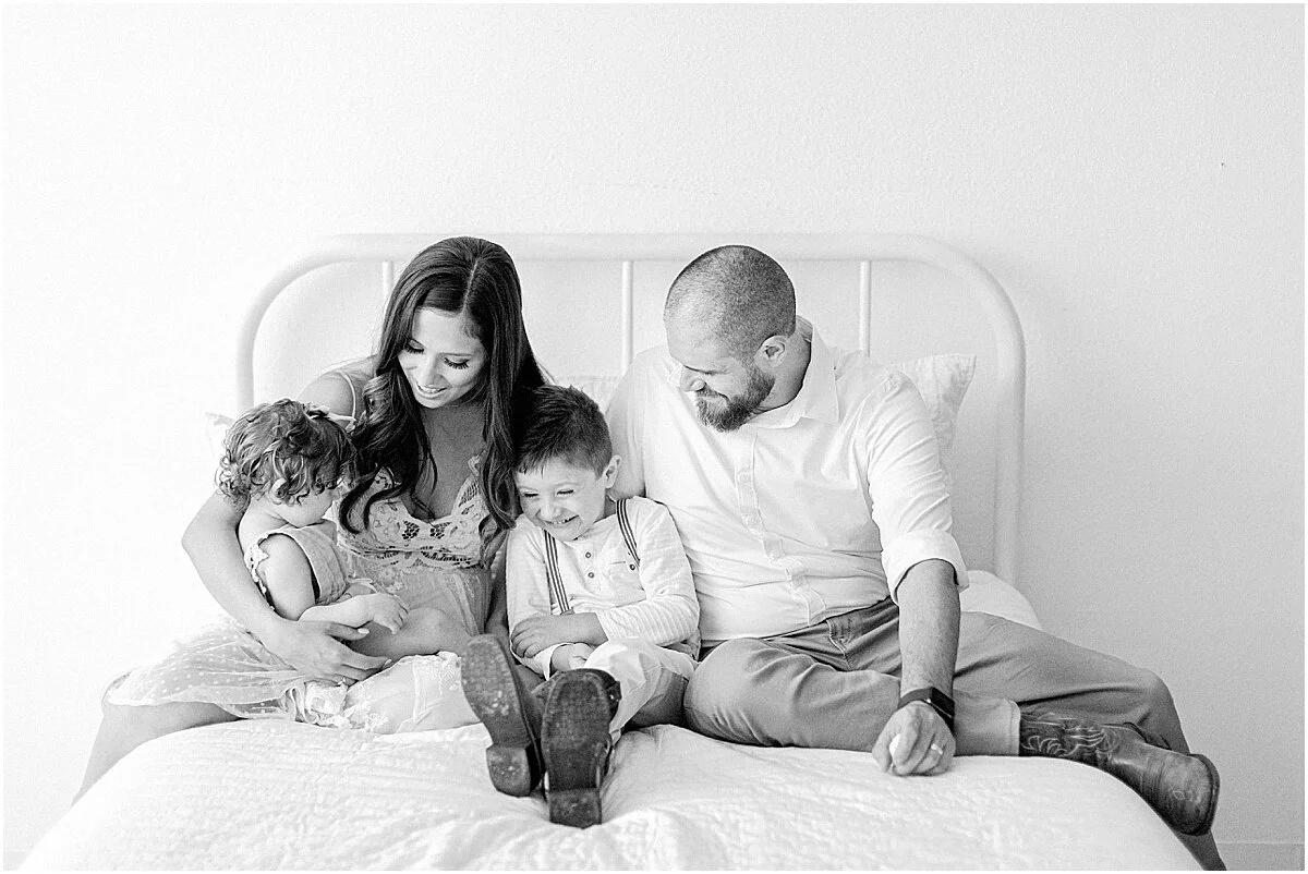 Flower Mound Family Photographer, Dallas family photography, studio session, family giggling on bed, black and white portrait, dfw family photographer, colleyville photographer, southlake family photographer, coppell family photography