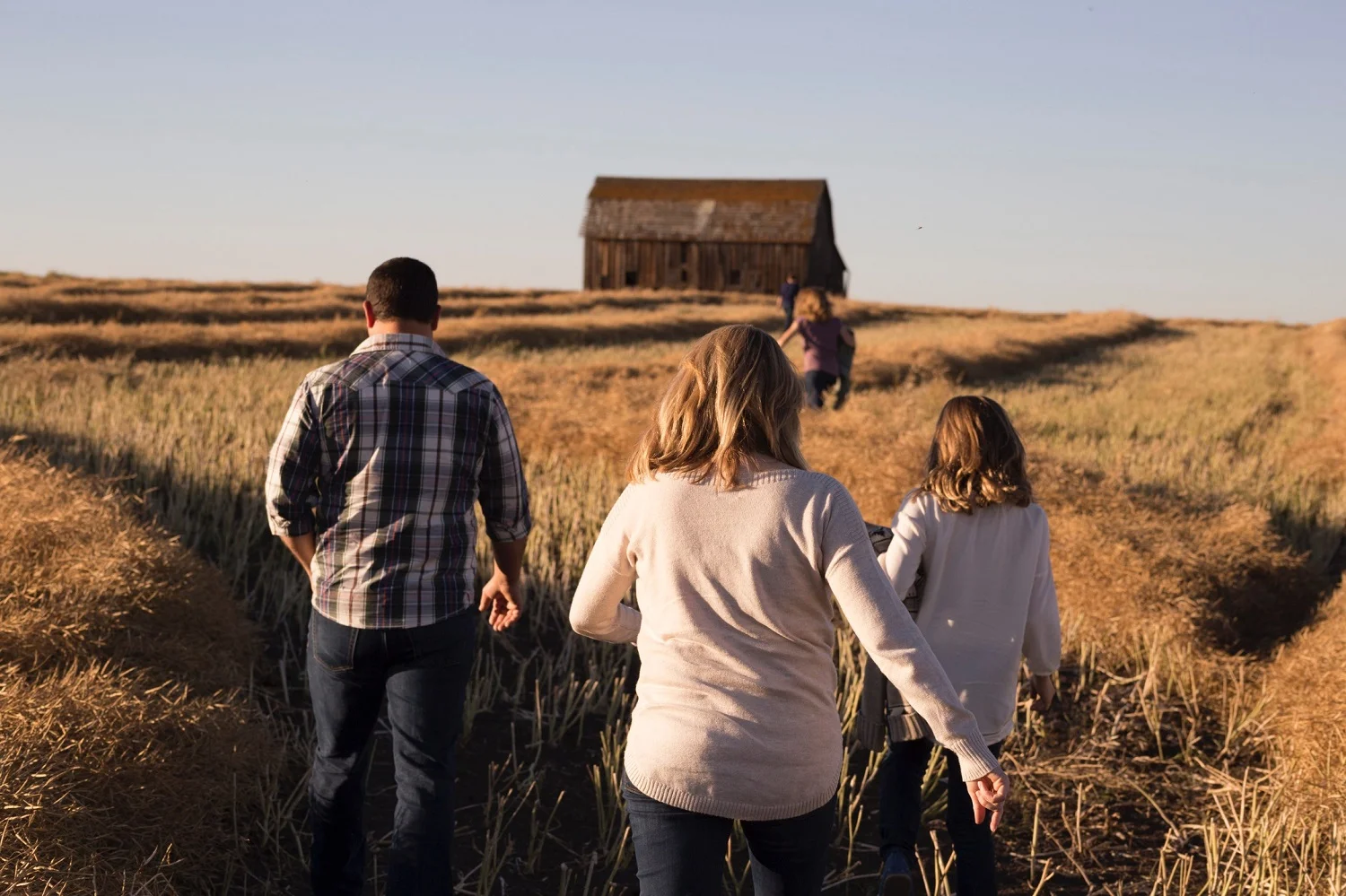 family walking in field toward barn.jpg