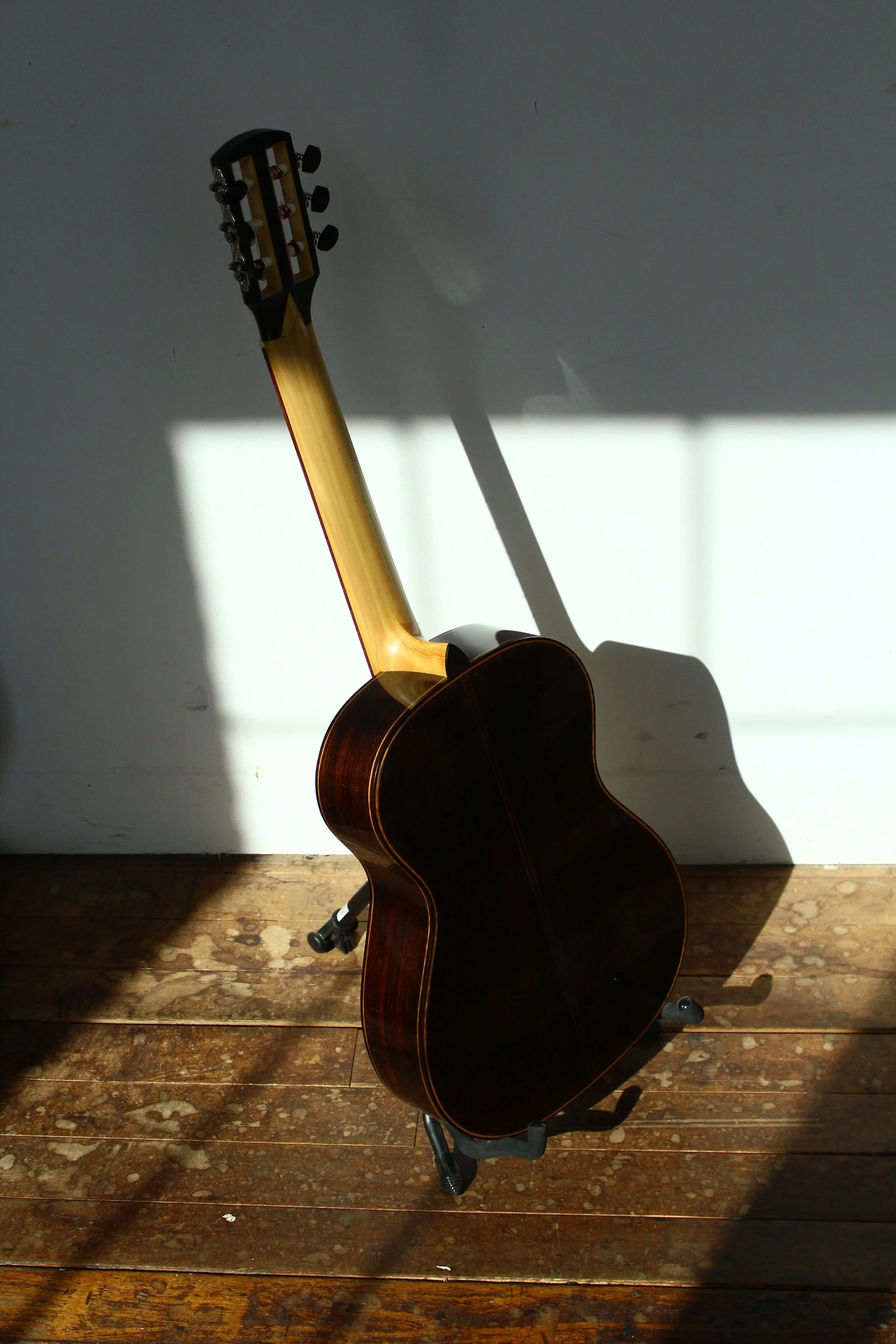 Classical guitar in sunlight photographed outside of the Queen City Guitars shop at the Cotton Mill in Brattleboro Vermont
