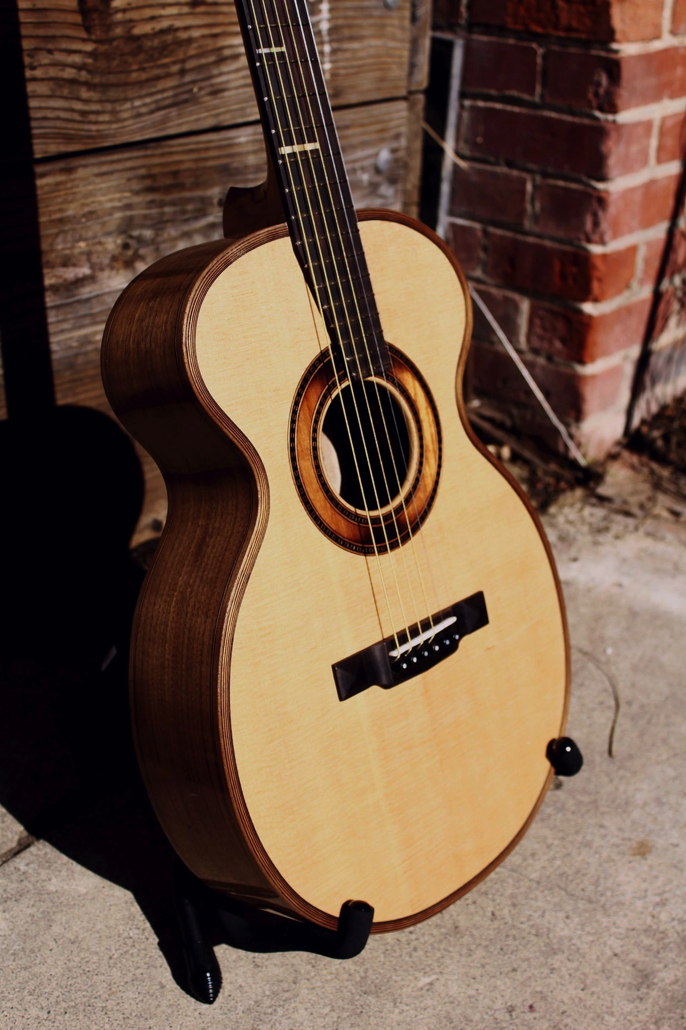 Black walnut and spanish cedar custom acoustic steel string guitar with sand shaded rosette hand crafted by luthier Aaron Foster of Queen City Guitars