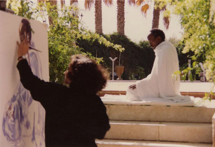 Halla painting Al Tahiyat, at the Artists’ home in Riyadh, 1992