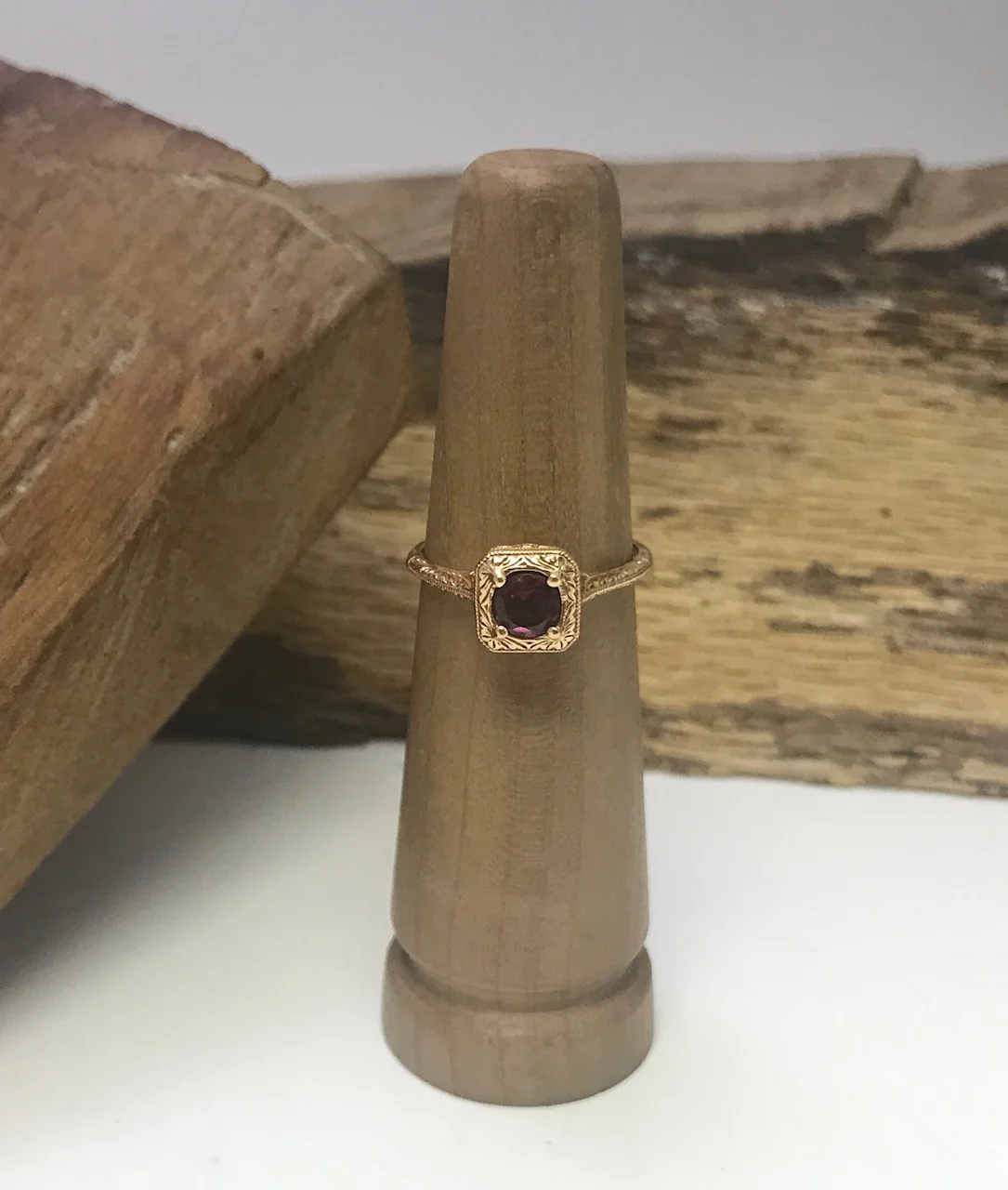 14 K Rose Gold with a Rhoda-lite Garnet. 