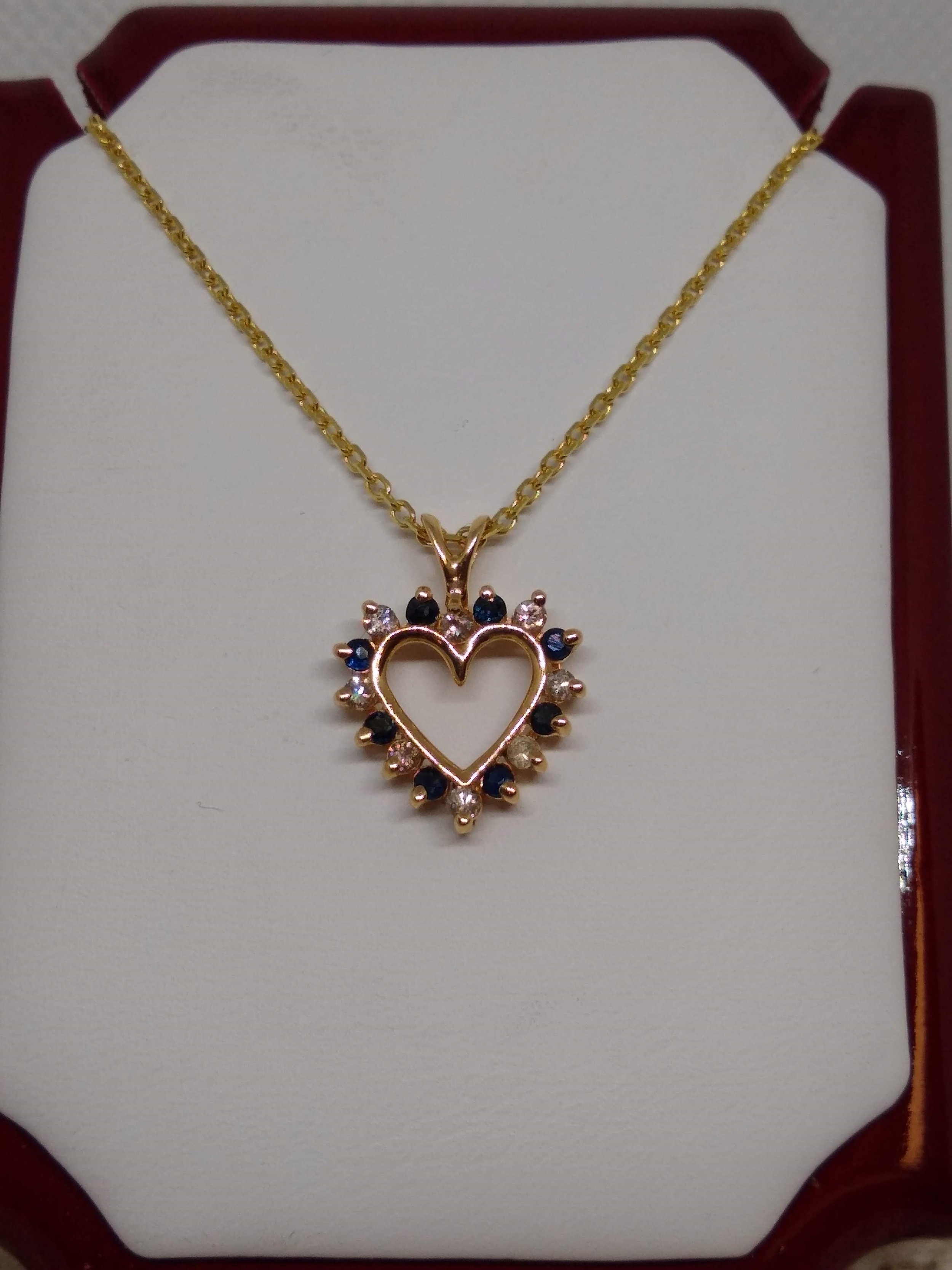 14k Yellow gold heart accented with diamonds and sapphires.