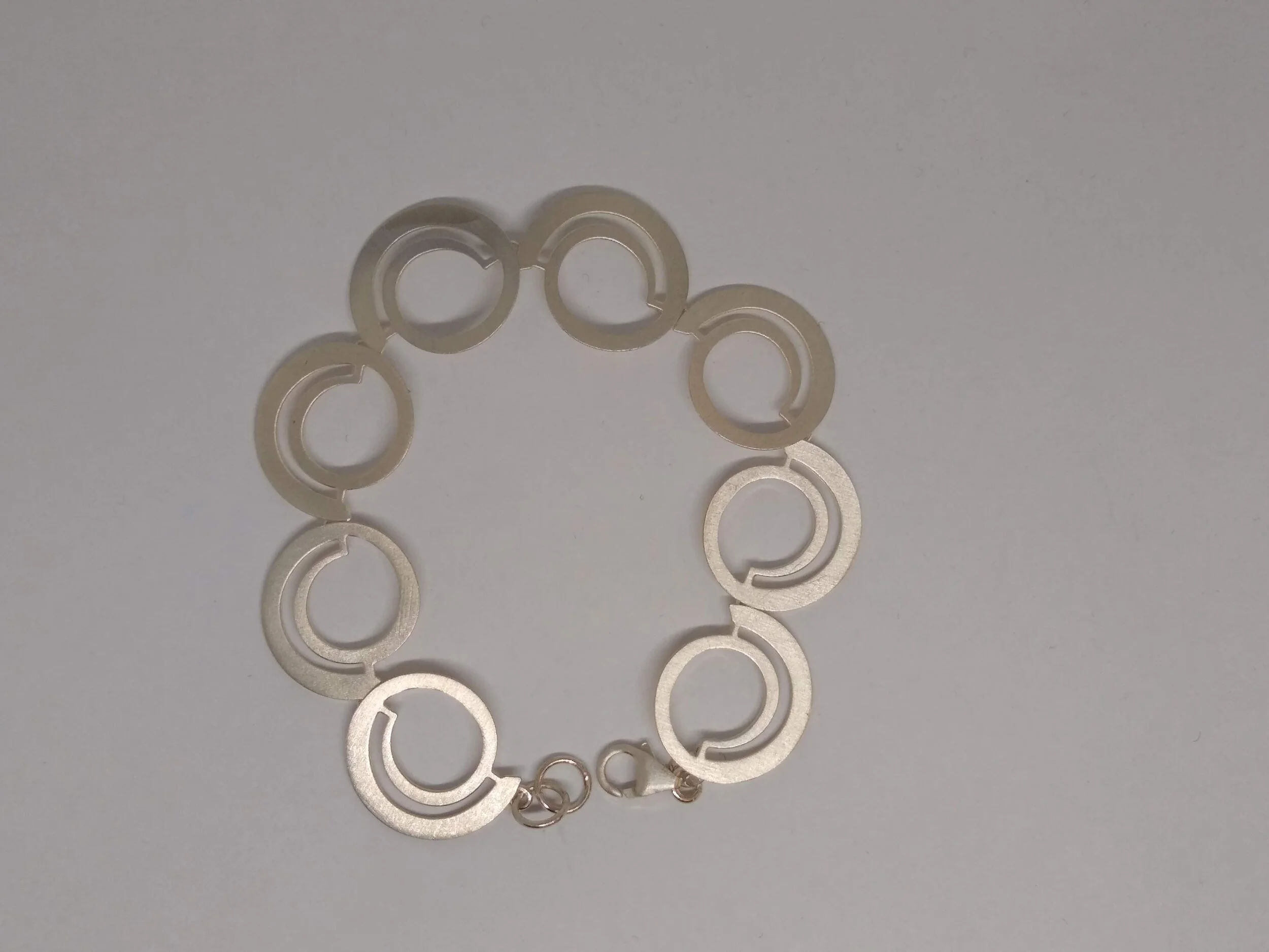 Kathy Lynn Mayeda (KLM)Brushed Sterling, Stylized Circle Bracelet.