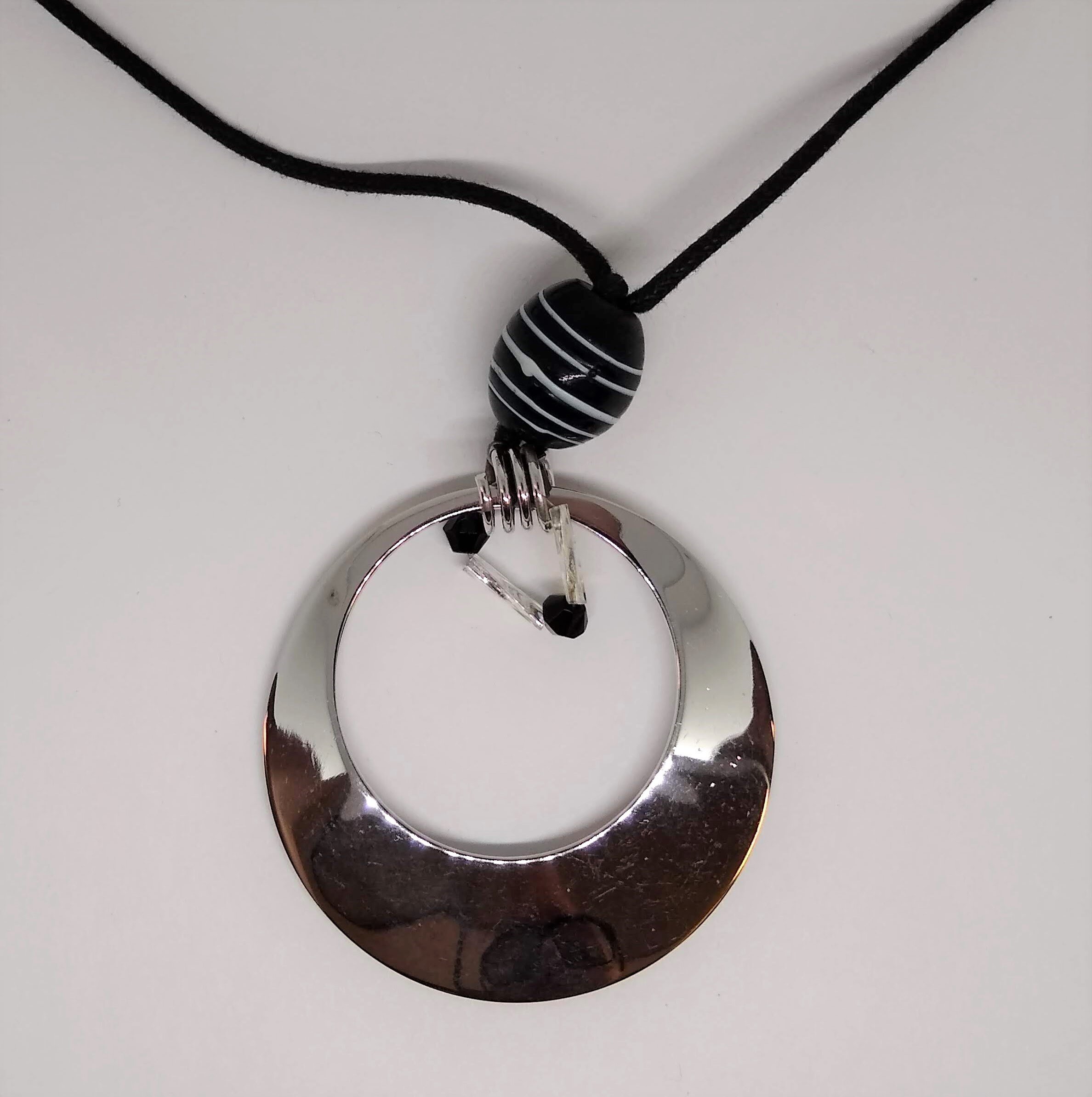 Contemporary Sterling,Large,Circular Pendant, on a black, adjustable, cord.