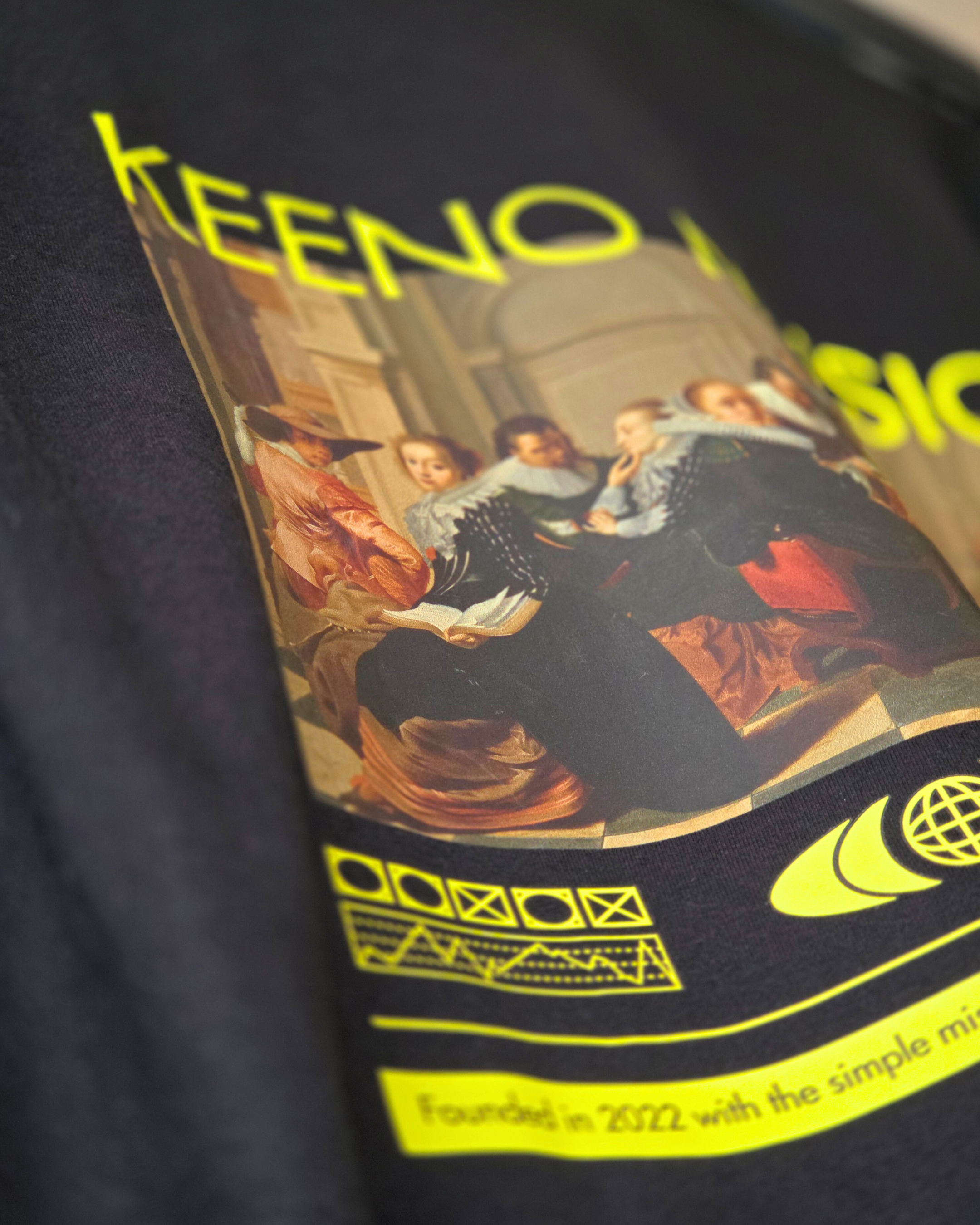 Close-up of a label on a product with yellow and black design, showing part of a scene with people and some text, including the year 2022.
