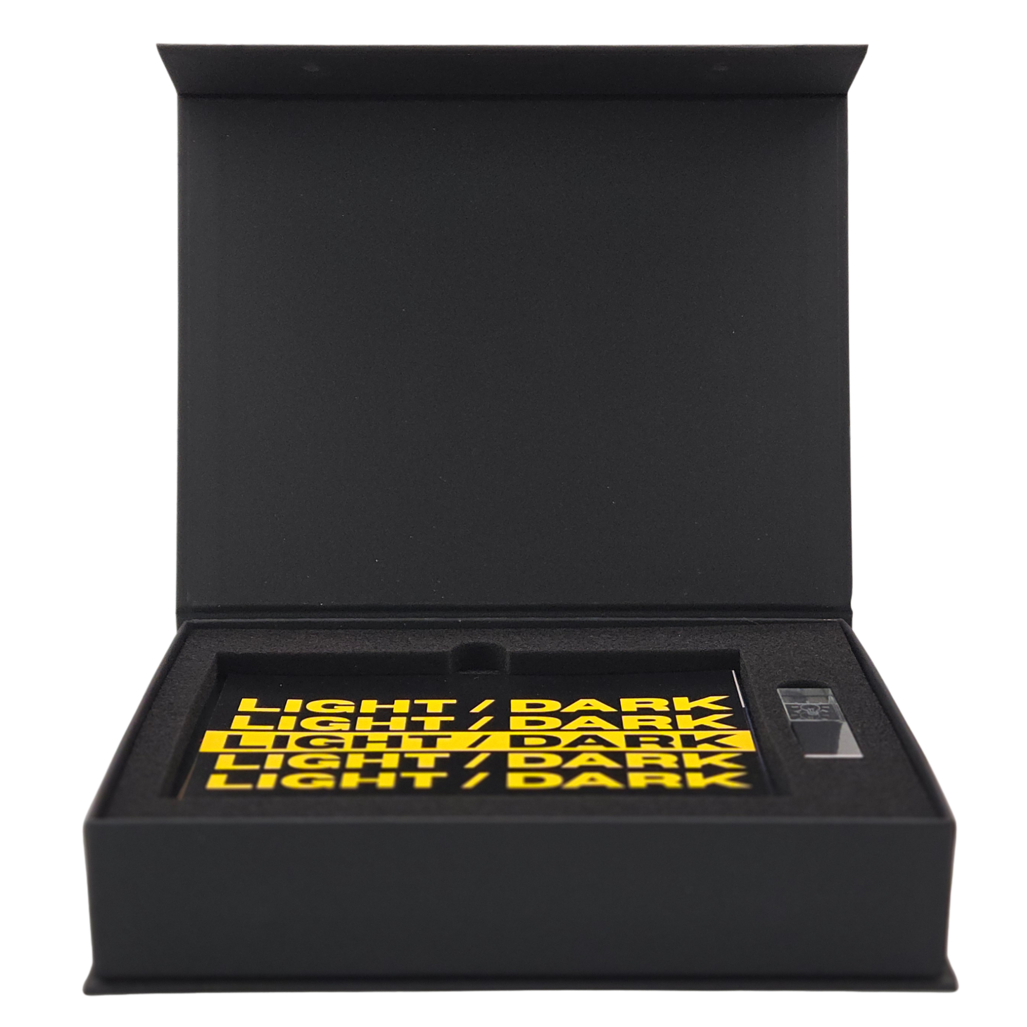 Black box with yellow text on the inside of the lid that says 'LIGHT / DARK'