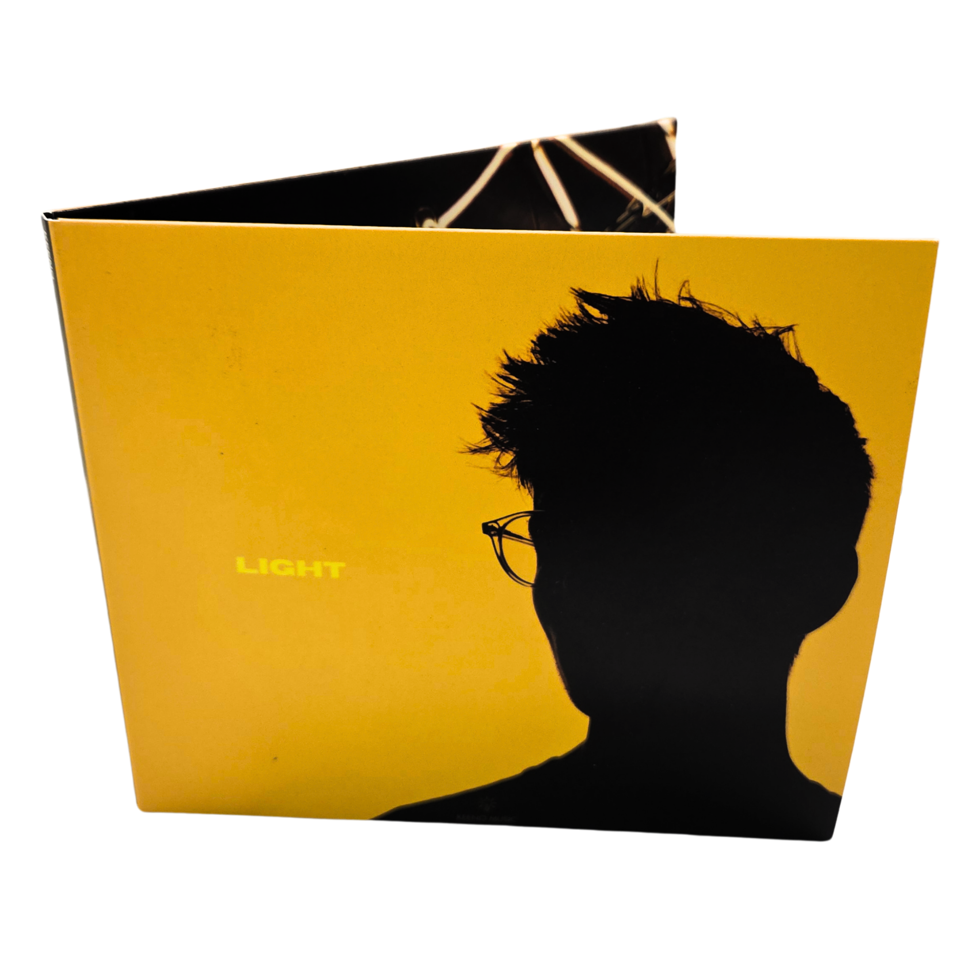 Close-up of a book cover with a bright yellow background, black silhouette of a person's head with spiky hair, and black sunglasses. Part of the title 'LIGHT' is visible in yellow text.