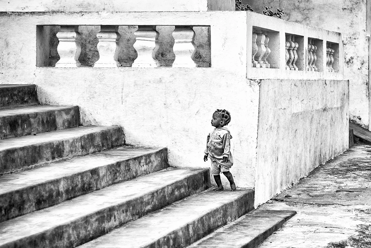 Girl on Stairs of Hospital in Ruins
