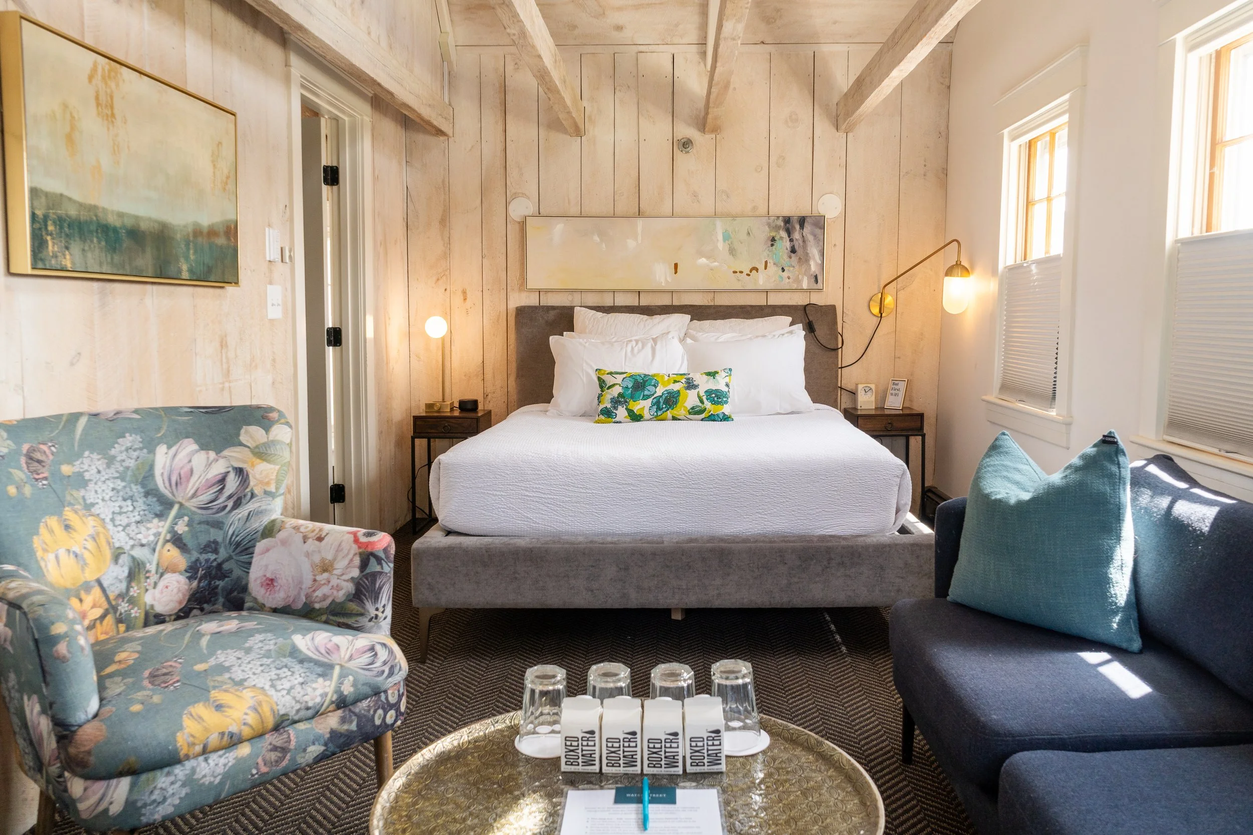 Bedroom in Room 8 at Water Street Inn with wood-paneled walls and queen bed