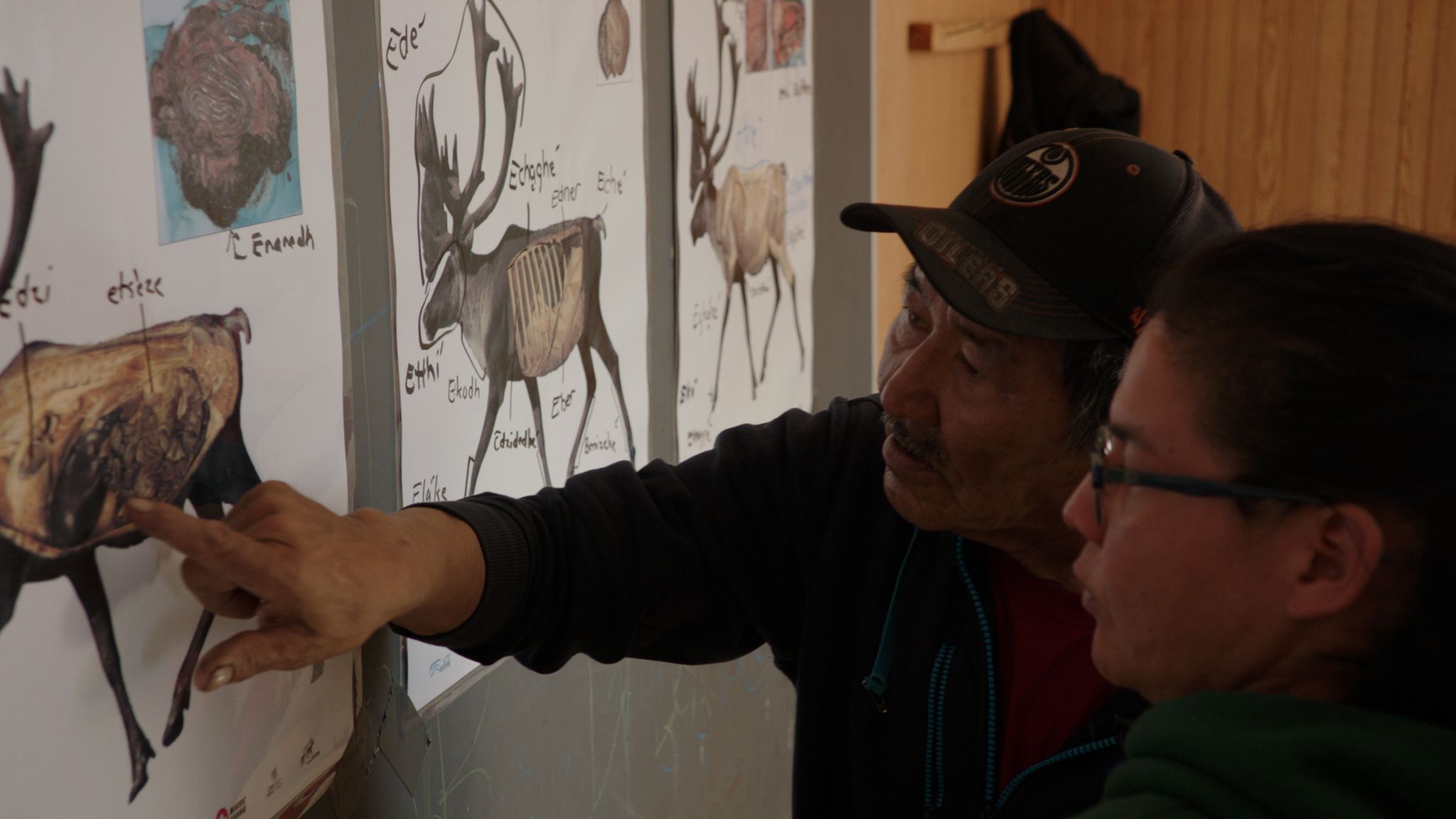  Elders in Wollaston Lake, Saskatchewan teach younger generations about butchering caribou meat. 