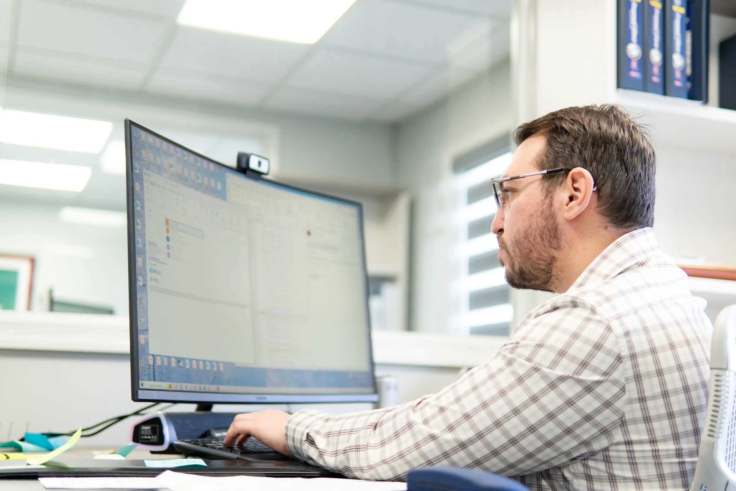 Neal Property Management team member working at a computer in the office