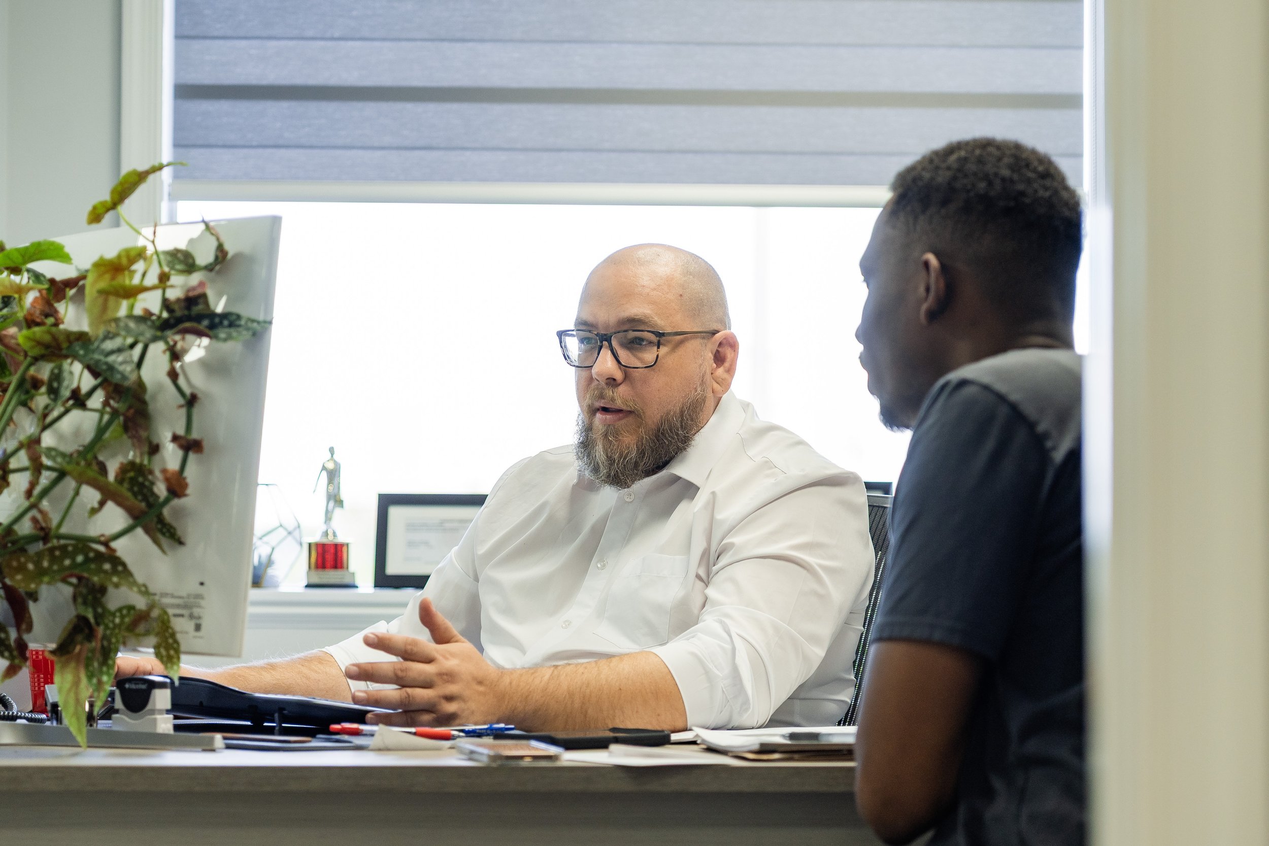 Neal Property Management team member meeting with a client in the office