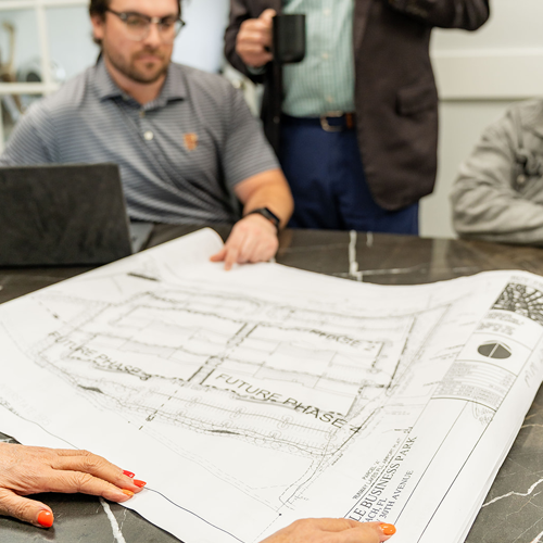 Neal Realty team reviewing architectural plans for a commercial property