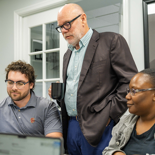Tim Neal and Neal Realty team members discussing commercial property plans