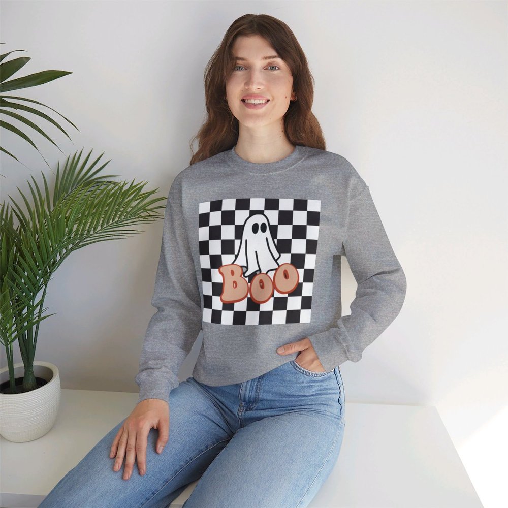 Halloween Boo Crewneck Sweatshirt with Cute Aesthetic Ghost and Black Checkered Background. Printed on a Unisex Heavy Blend Crewneck Sweatshirt The