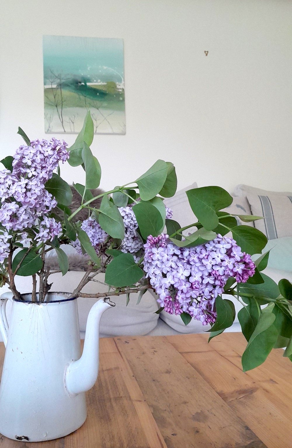 Seethrough hanging in the living room with lilacs