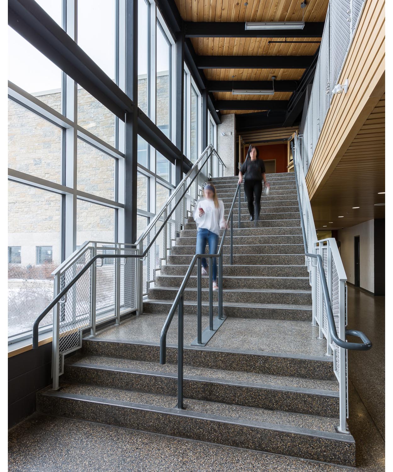  Northlands Parkway Collegiate, interior photo of staircase with people descending / Photo:  Lindsay Reid  