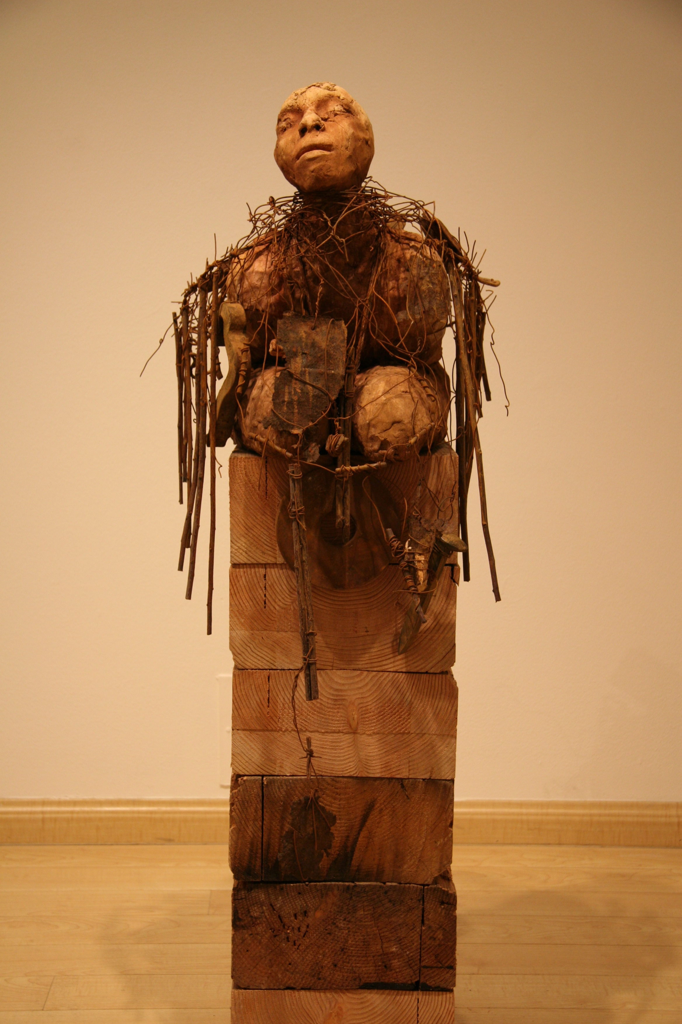 Unconscious forgetfulness 2006-2007 Ceramic, wire, branches with rusted objects 50 x 17 x 24 The figure is weighed down and entangled in detritus of the past that is evidence of suffering that leads to renewal.