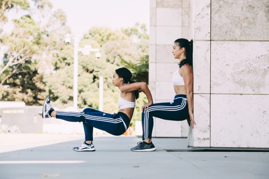 Partner 1 - 30 Tricep Dips. Bend your arms to 90 degrees while holding your partner’s knees. If this feels awkward, have Partner 2 widen their stance. Without letting your elbows splay outwards, push up until your arms are nearly straight. Repeat 30 times.