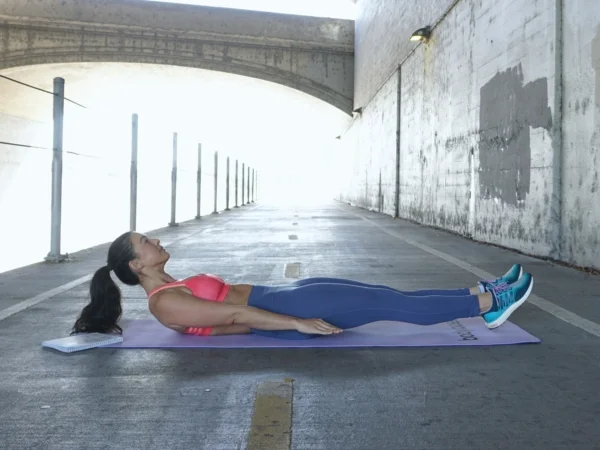 Start on your back with your feet and shoulders hovering above the ground,