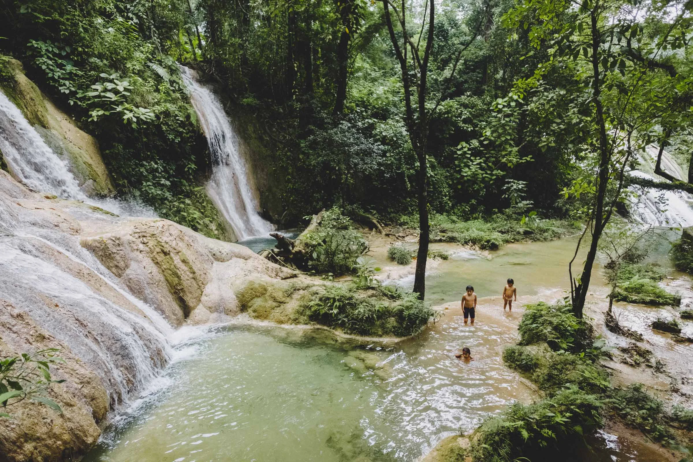 Next we pulled into the Cascadas de Agua Azul, a series of frothy white falls and bright blue pools where we went for a quick swim. The water's impossible blue is due to a high mineral content which slowly percolates out fo the water and encases rocks and trees alike in a thick shell of limestone. Like Misol-Ha, these falls see fair amount of local and tourist traffic, and the area has been built up in the past decade with little restaurants and shops and other amenities. The falls were stunningly beautiful, but it was hard not to try imagine what it would have looked like before all the shops were quickly erected. But then again, we also didn't pack a lunch so being able to grab a bite was pretty nice.