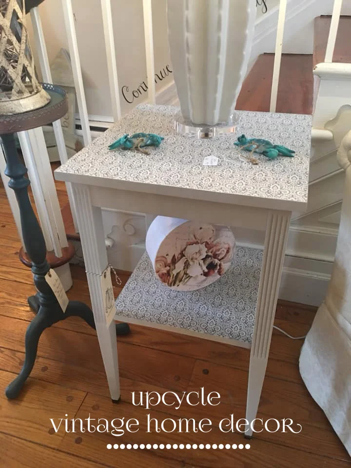 Painted table with decoupaged tissue on shelf and top.