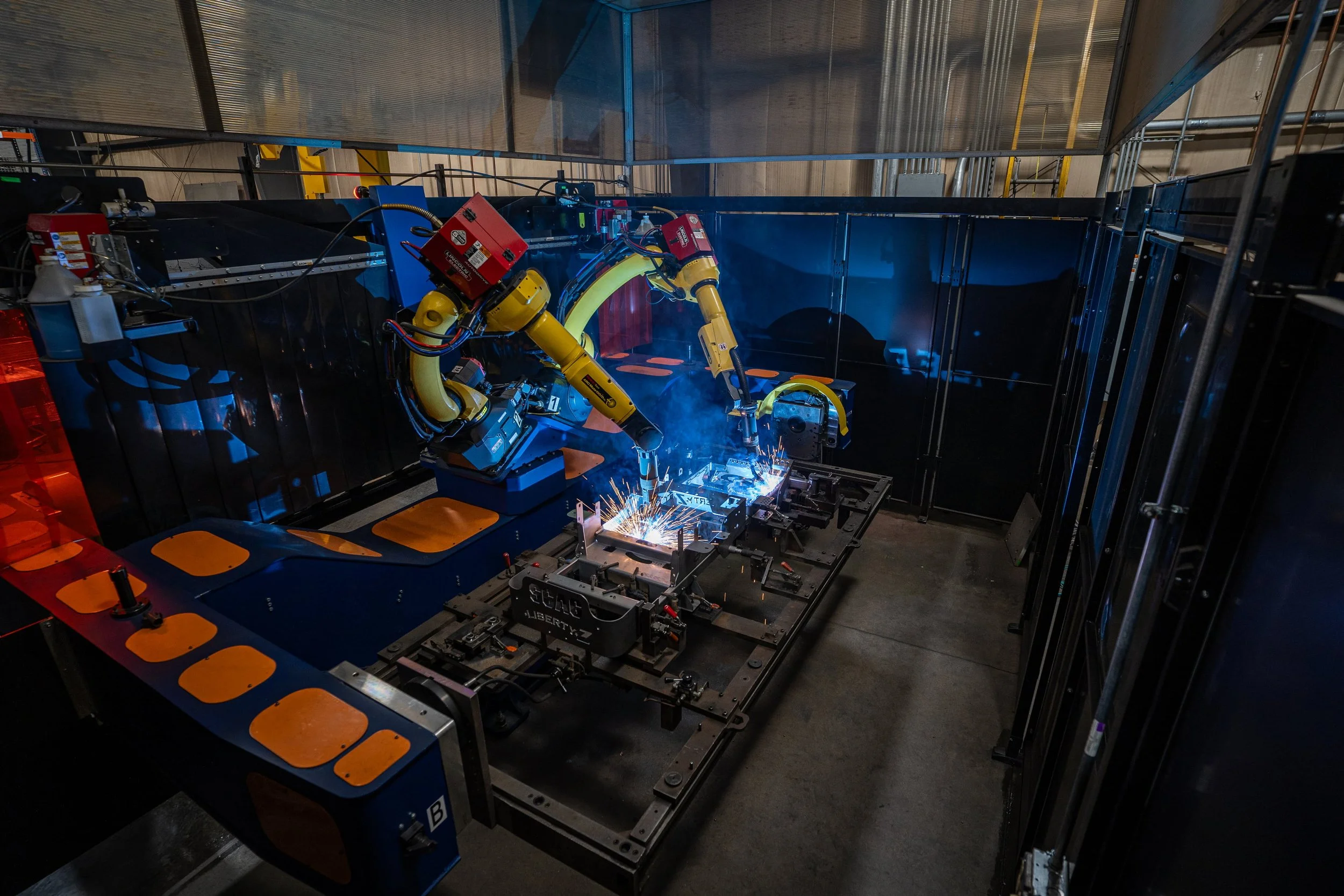  Two Fanuc robots welding a Scag mower frame 