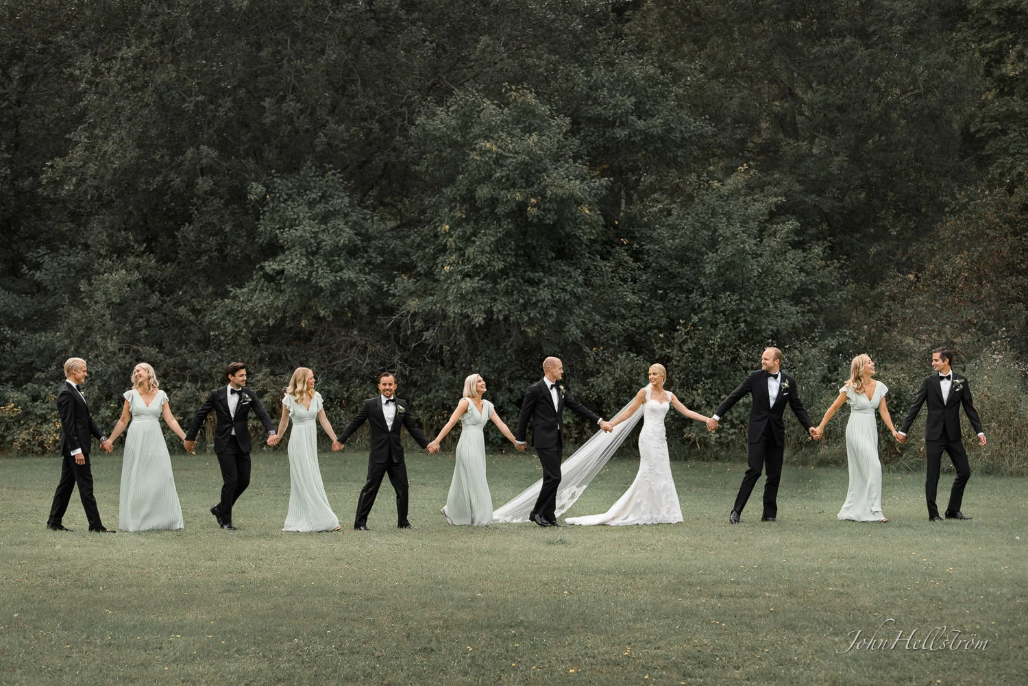 Wedding couple with friends walking to the wedding ceremony