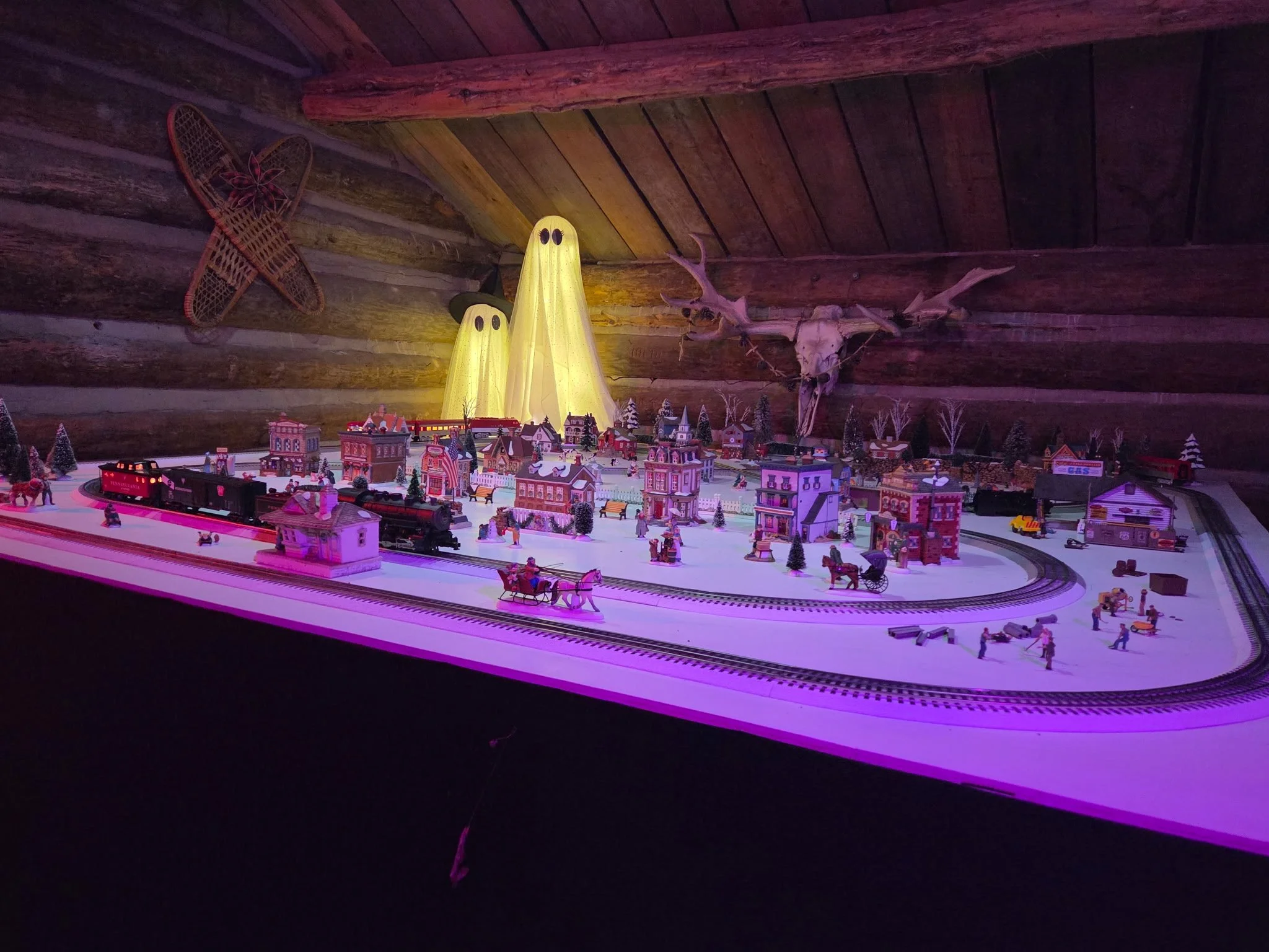 A detailed miniature railroad village receives a ghostly Halloween makeover.
