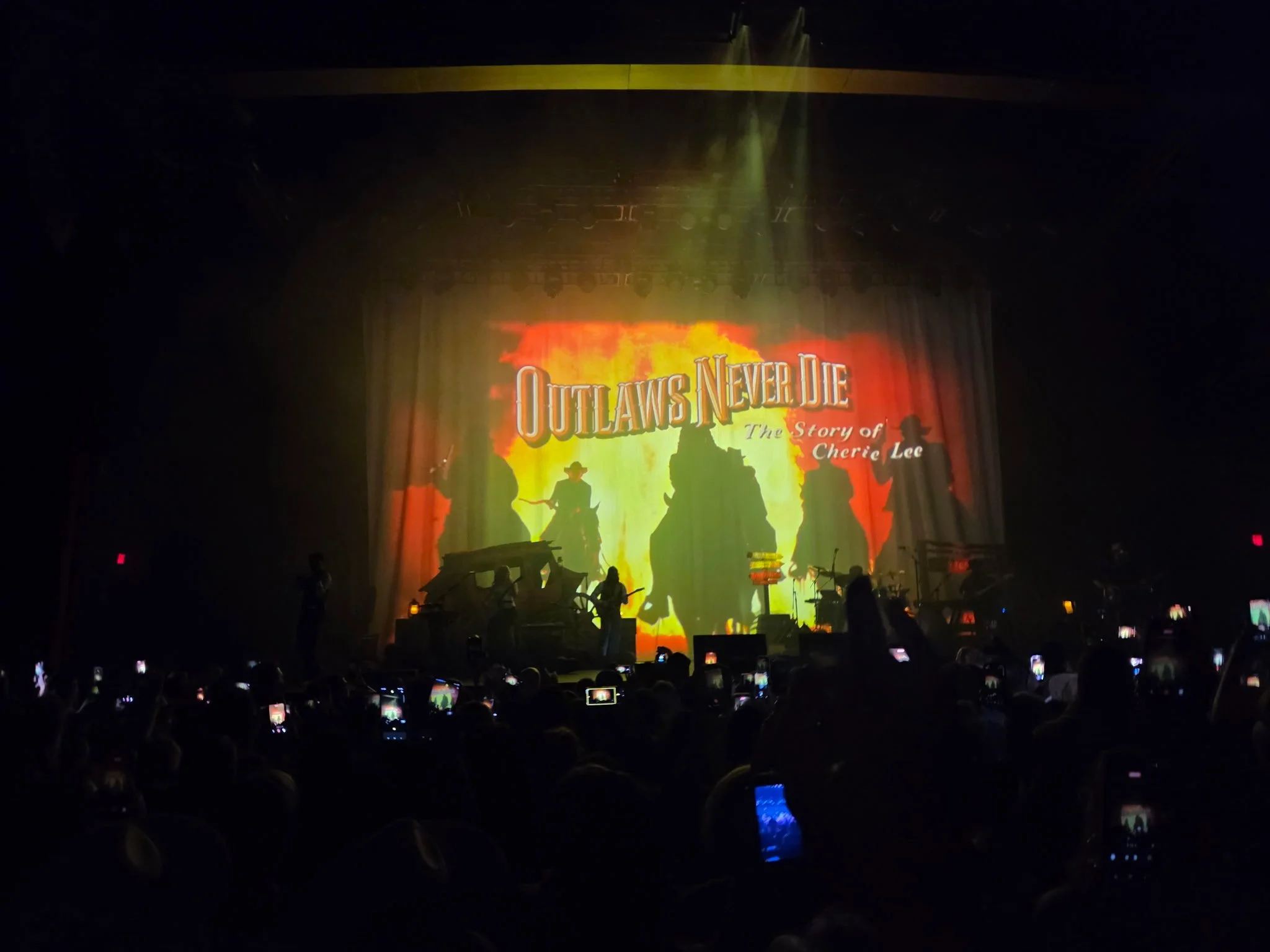 Outlaws Never Die Western stage projection during Shaboozey's concert at MGM Music Hall at Fenway in Boston.