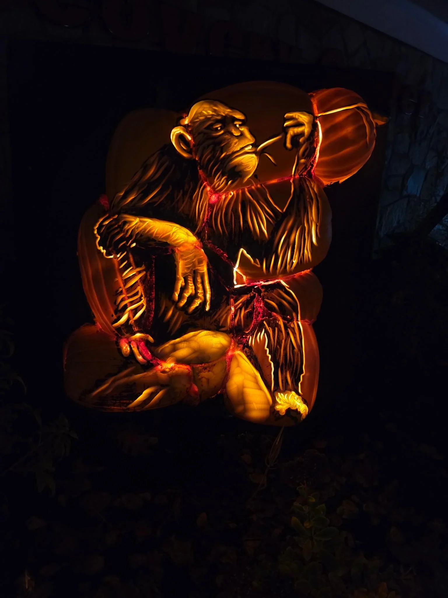A detailed primate carving demonstrates the artistry behind the illuminated wildlife displays.