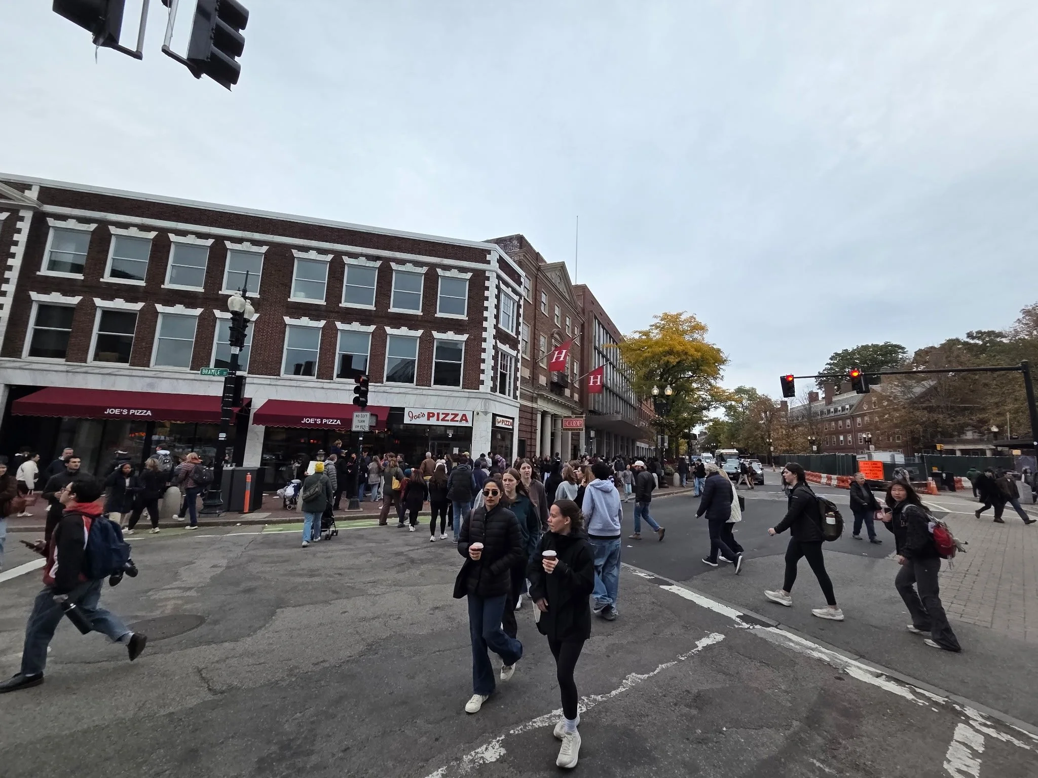 Harvard Square during Head of the Charles weekend, with busy sidewalks and historic Cambridge surroundings. Photo: GoBoston.