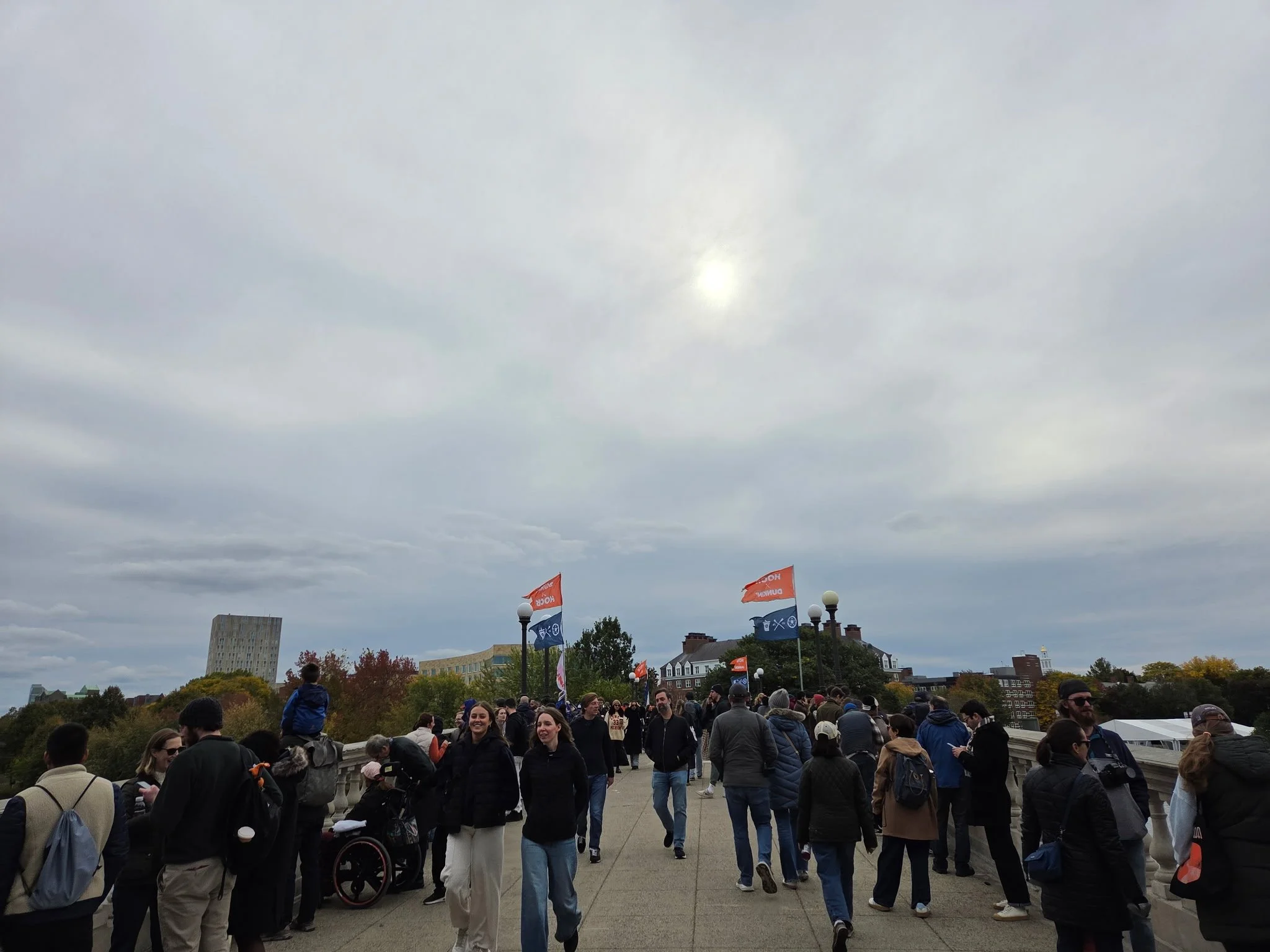 Crowds gather on Weeks Footbridge during Head of the Charles weekend in Cambridge. Photo: GoBoston.