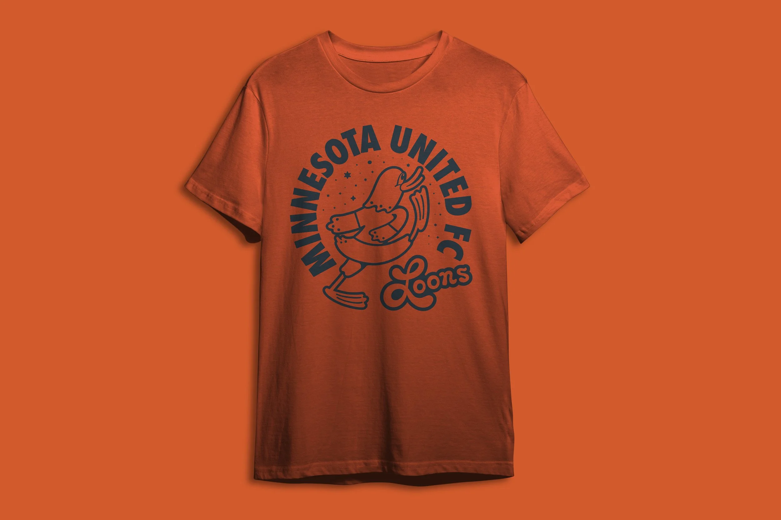 Orange T-shirt with a logo featuring a cartoon bird, and the text 'Minneapolis United FC' and 'Loons' on an orange background.