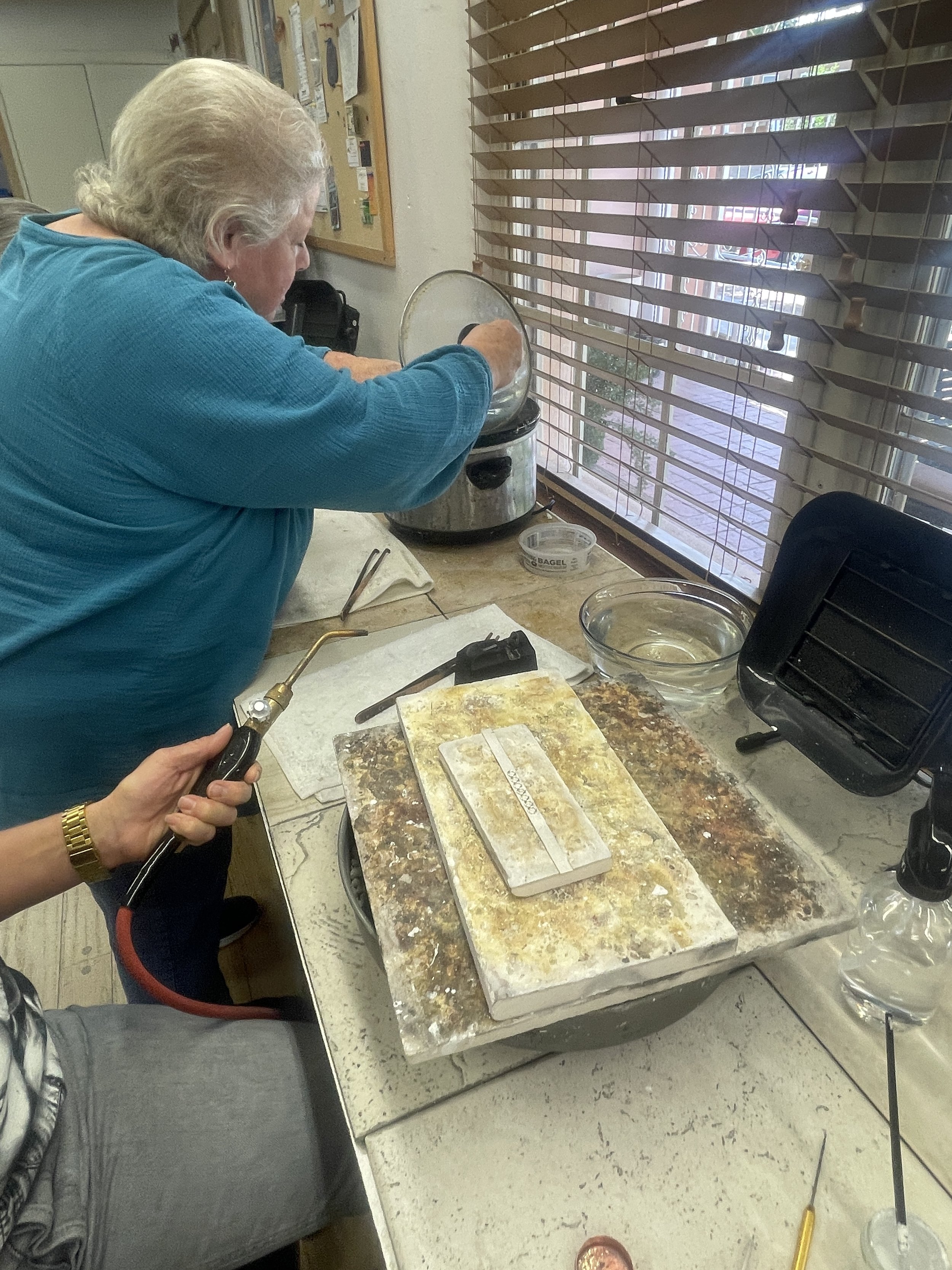 Stone setting process during a jewelry making class Albuquerque with silversmithing techniques