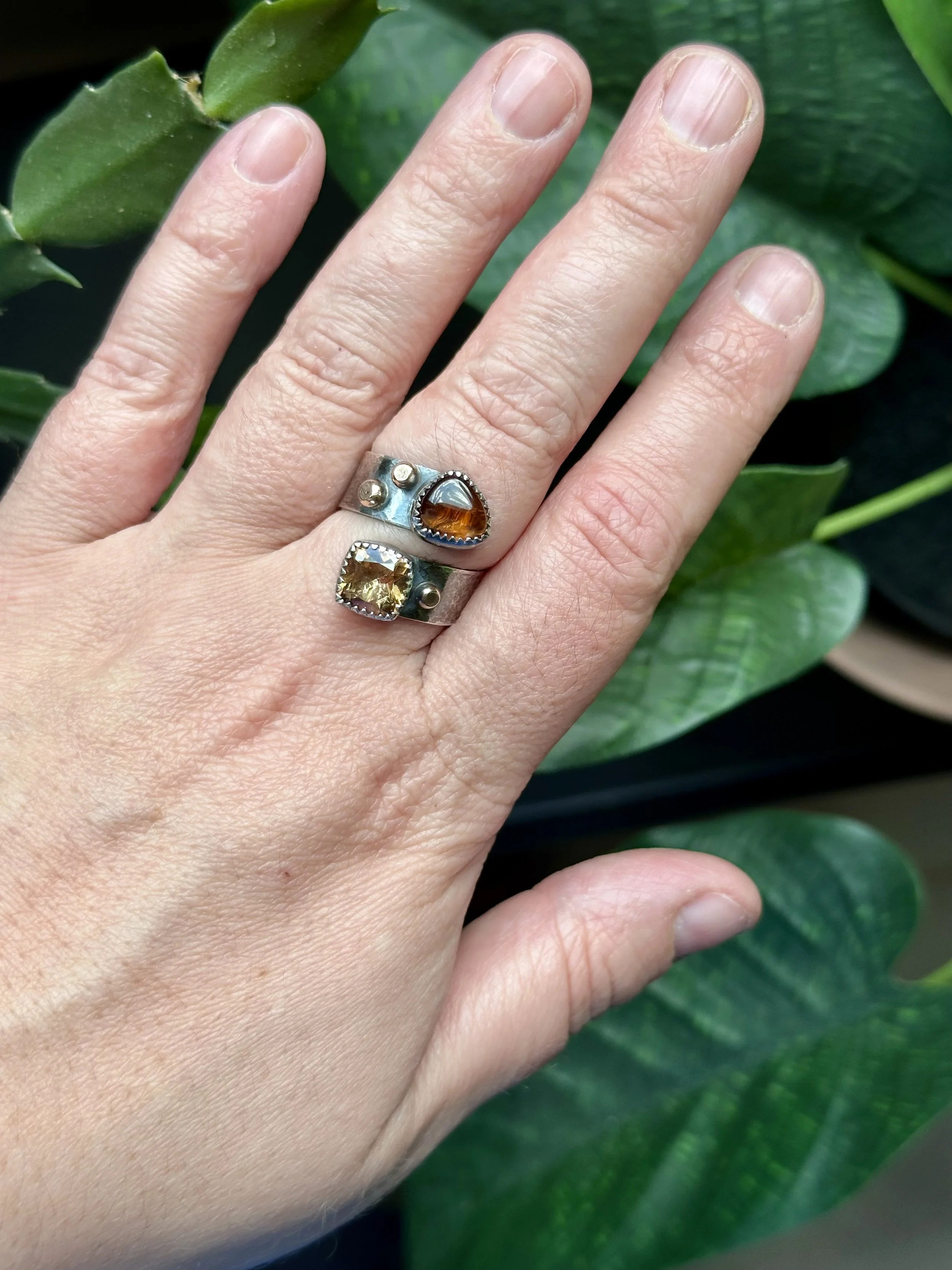Student wearing finished sterling silver tourmaline rings made in a jewelry making class at Meltdown Studio