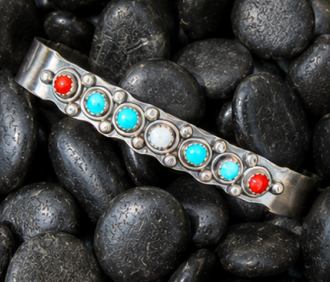 Handmade sterling silver cuff with turquoise and coral from a jewelry making class in Albuquerque