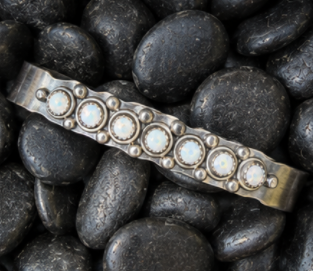 Polished silver cuff with bezel set stones from a jewelry making class in Albuquerque