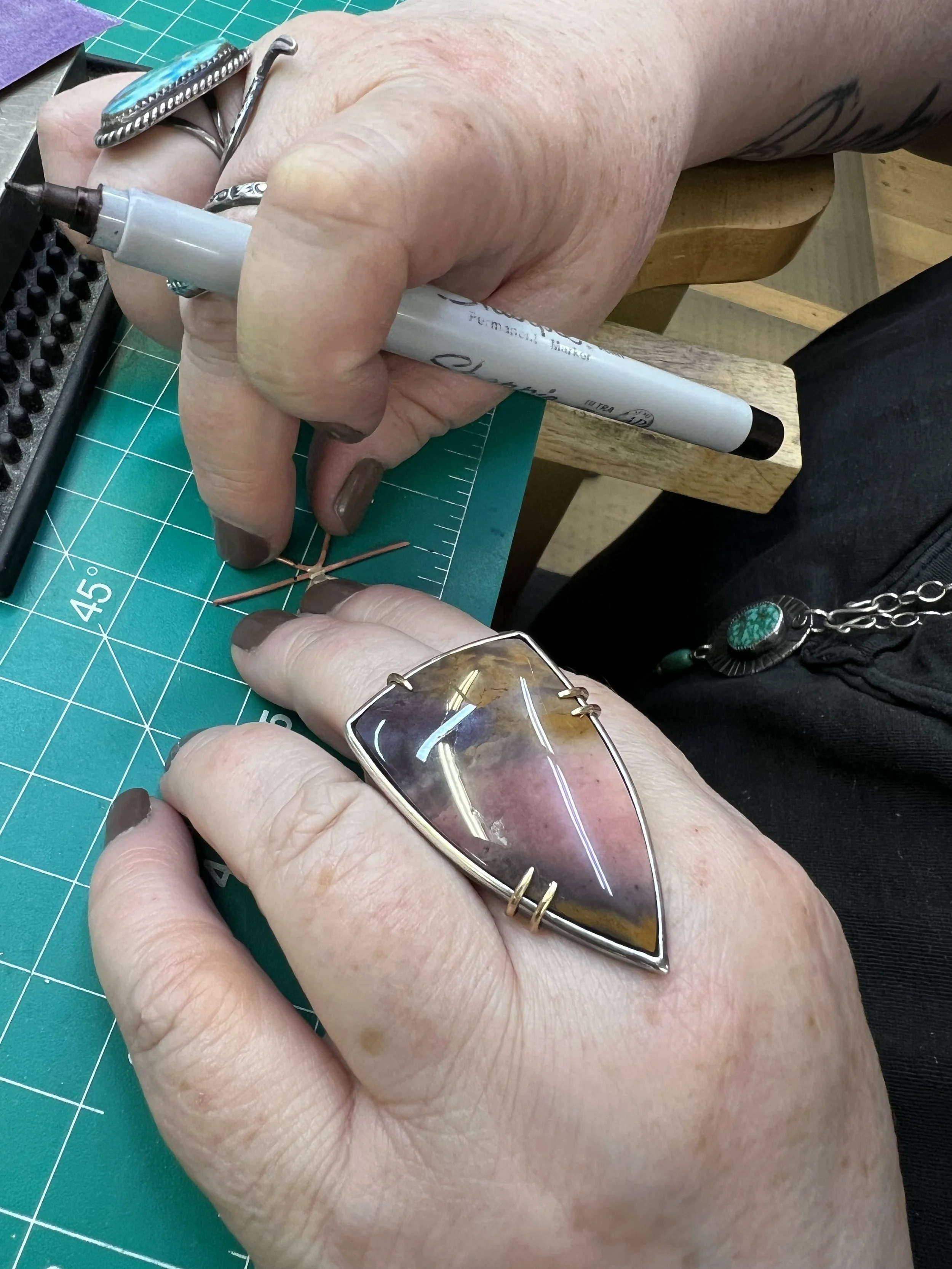 Student shaping a silver ring during a silversmithing class in Albuquerque