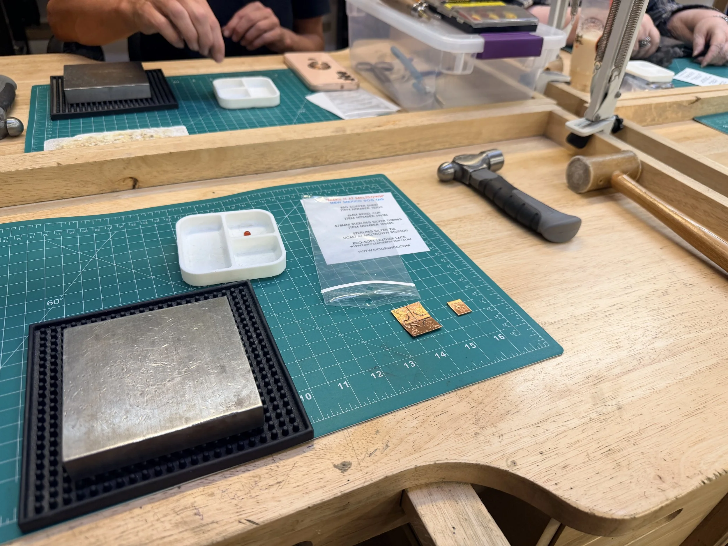 Jewelry making tools and materials laid out on a workbench during a jewelry making class in Albuquerque.