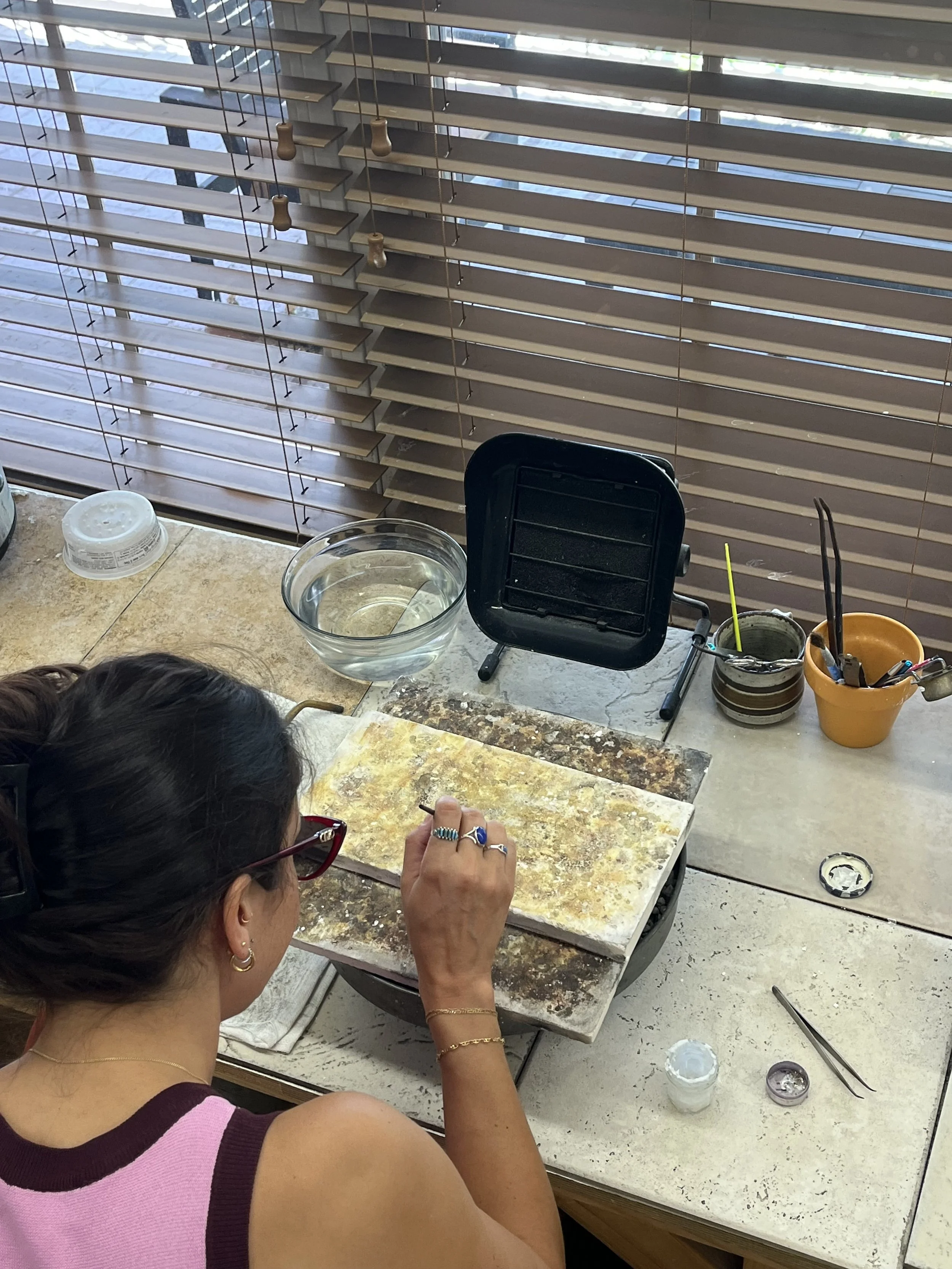 Student working at a bench during a jewelry making class in Albuquerque at Meltdown Studio 