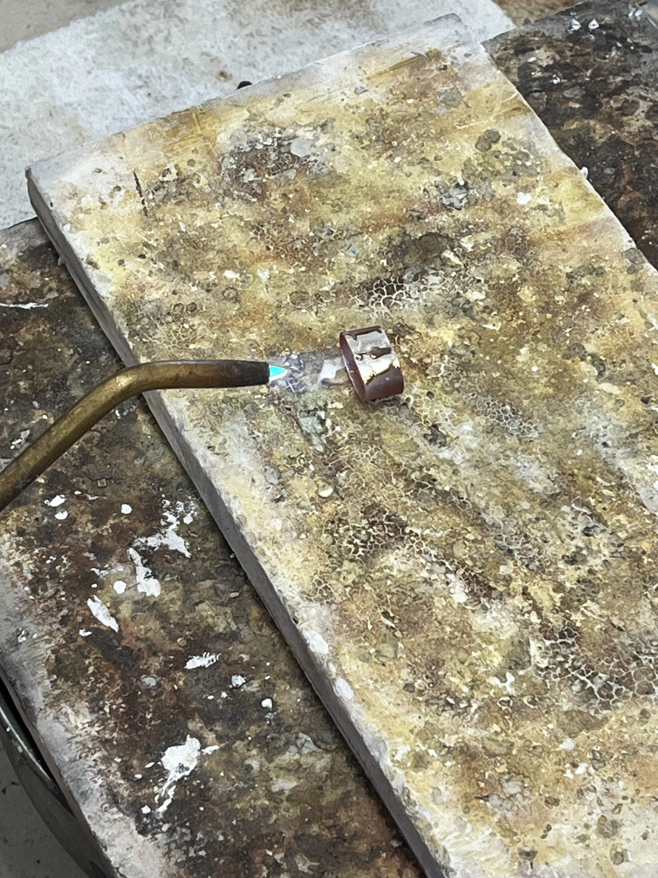 Close-up of soldering process in a spinner ring jewelry making class in Albuquerque