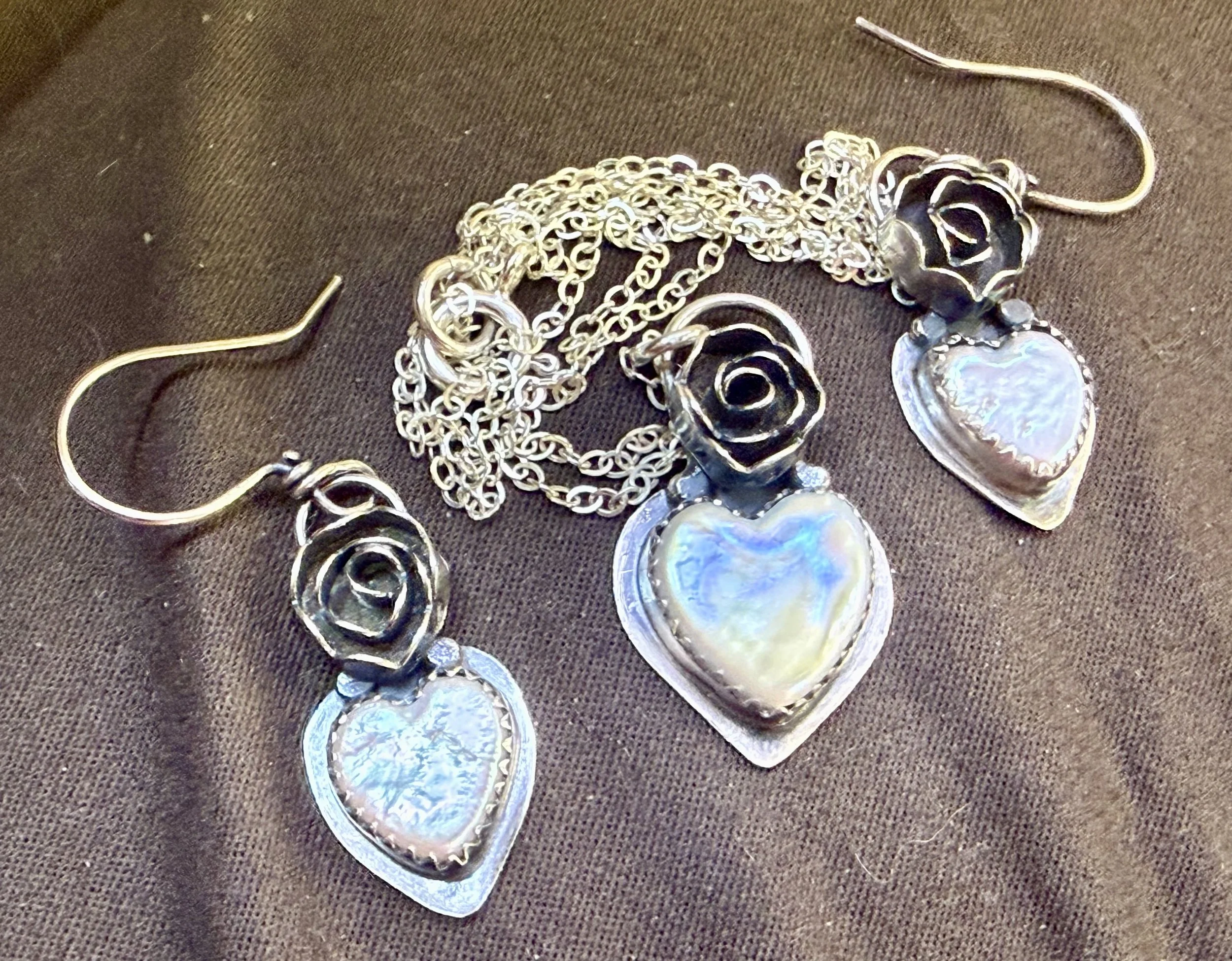 Silver rose and heart pendant necklace with matching earrings made during a jewelry workshop in Albuquerque