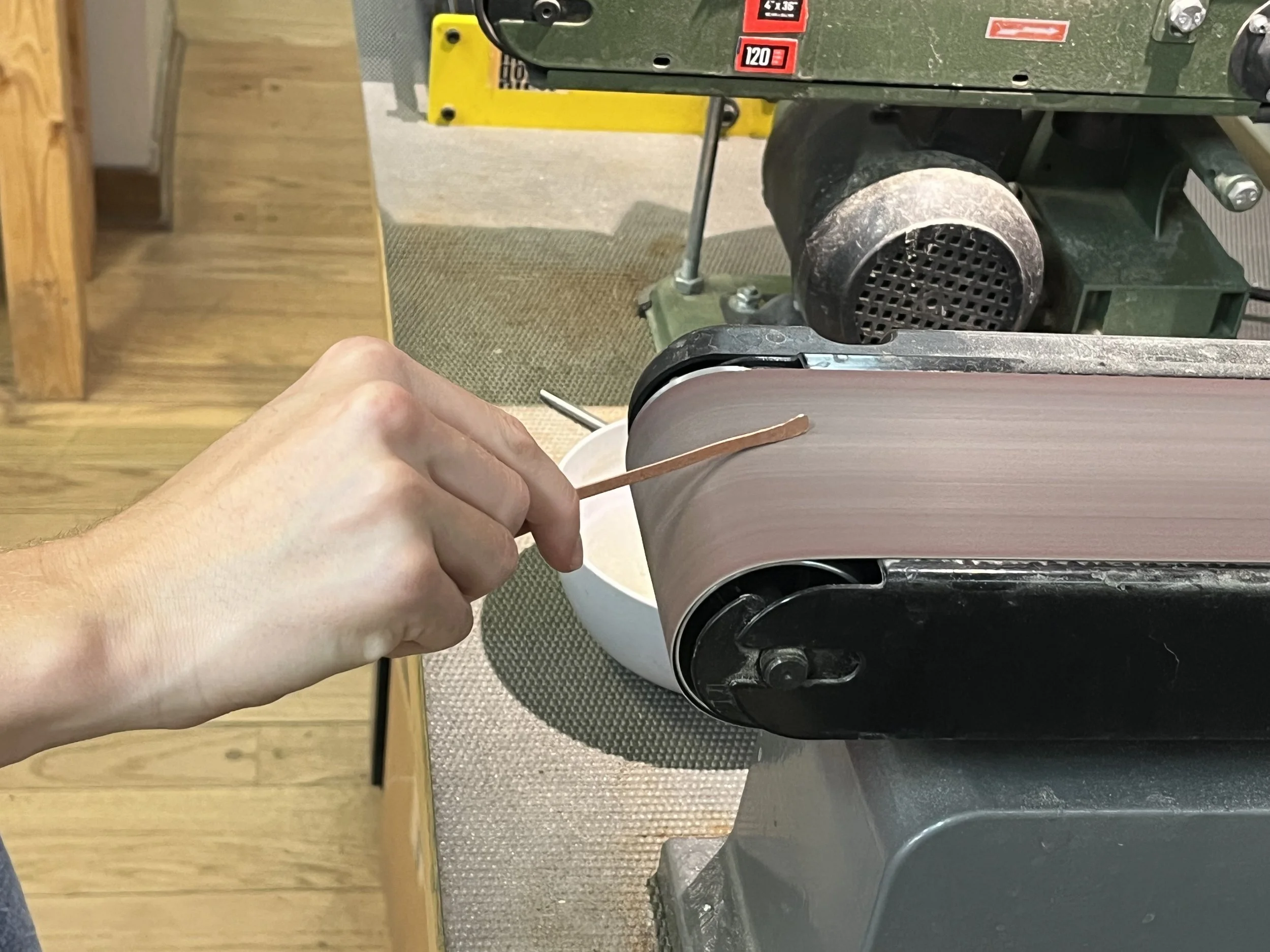 Sanding metal cuffs in private jewelry instruction Albuquerque