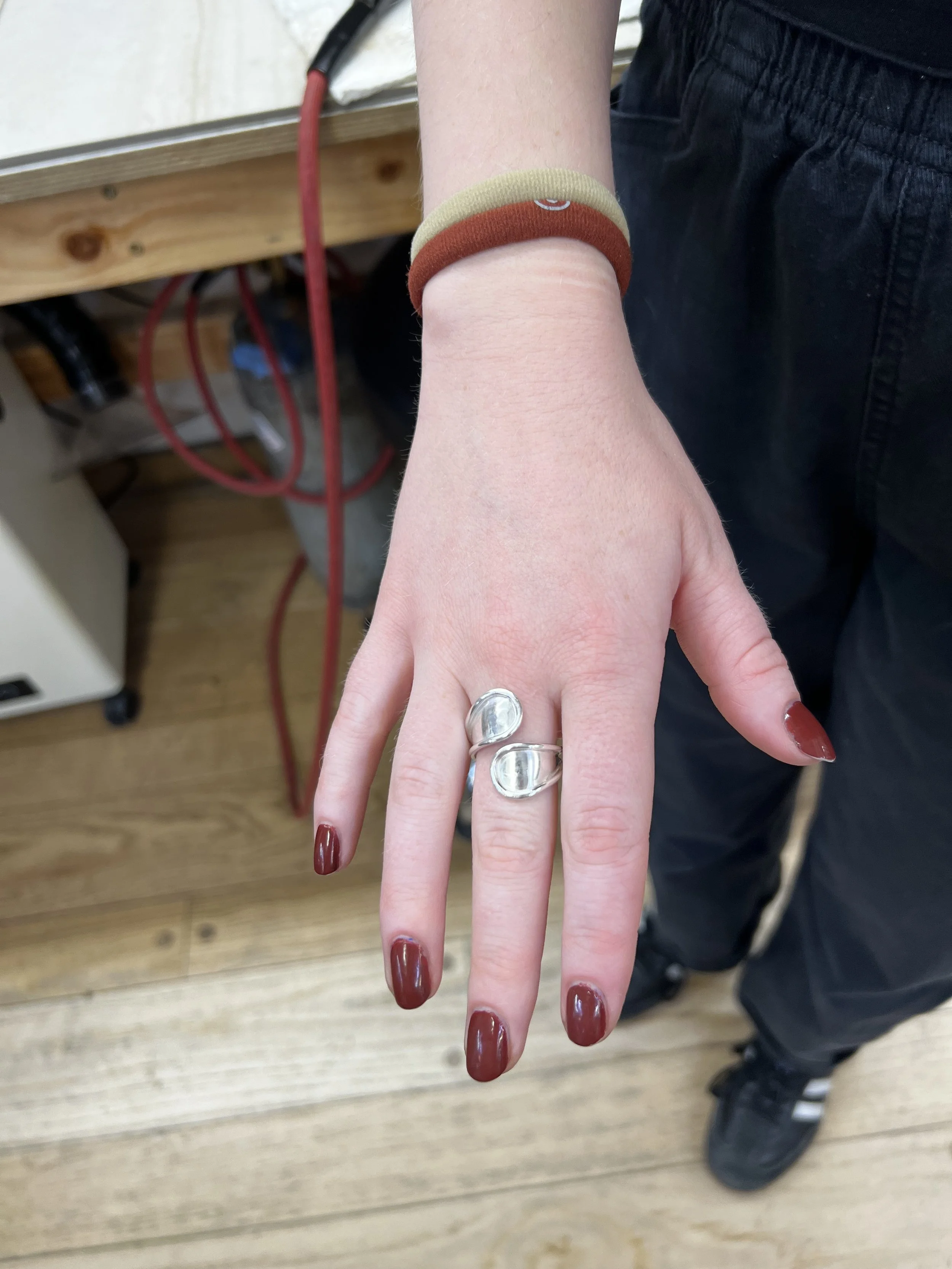 Silver ring setting before stone placement in jewelry making class