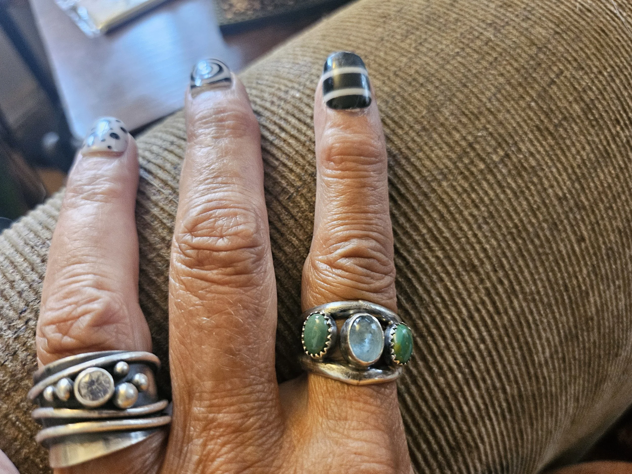 Hands wearing turquoise rings from a jewelry making class in Albuquerque