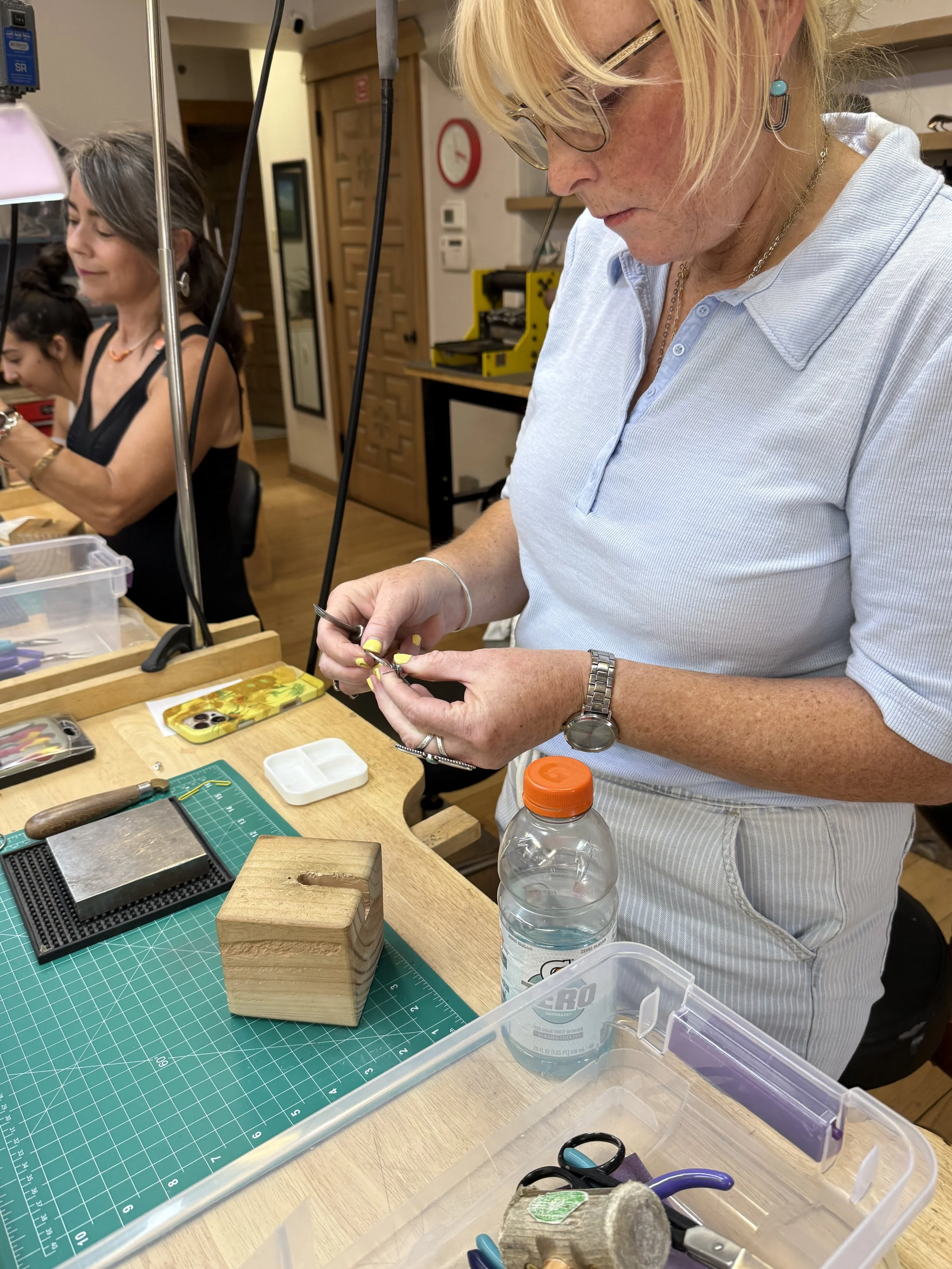 Students texturing silver hoops in a Jewelry Making Class in Albuquerque