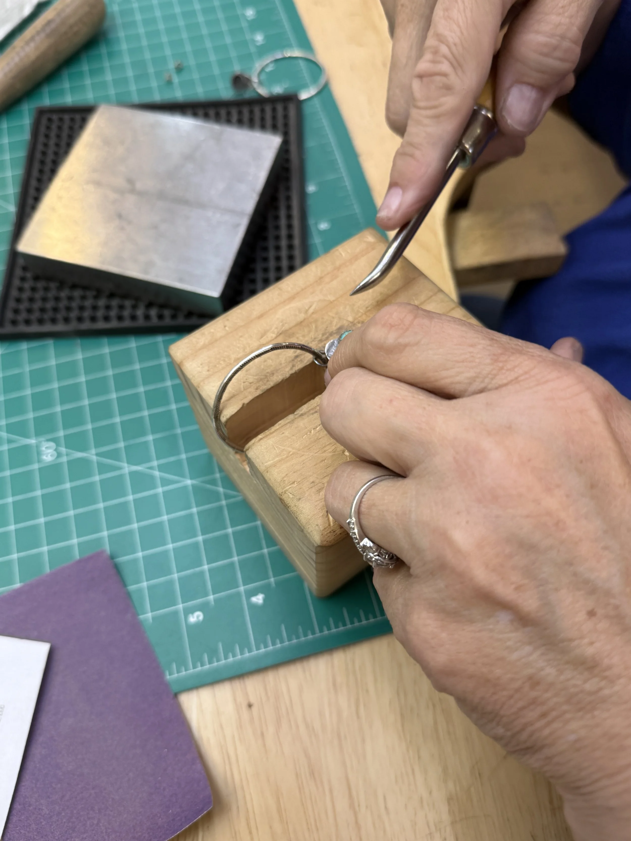 Students forming silver hoops in a Jewelry Making Class in Albuquerque