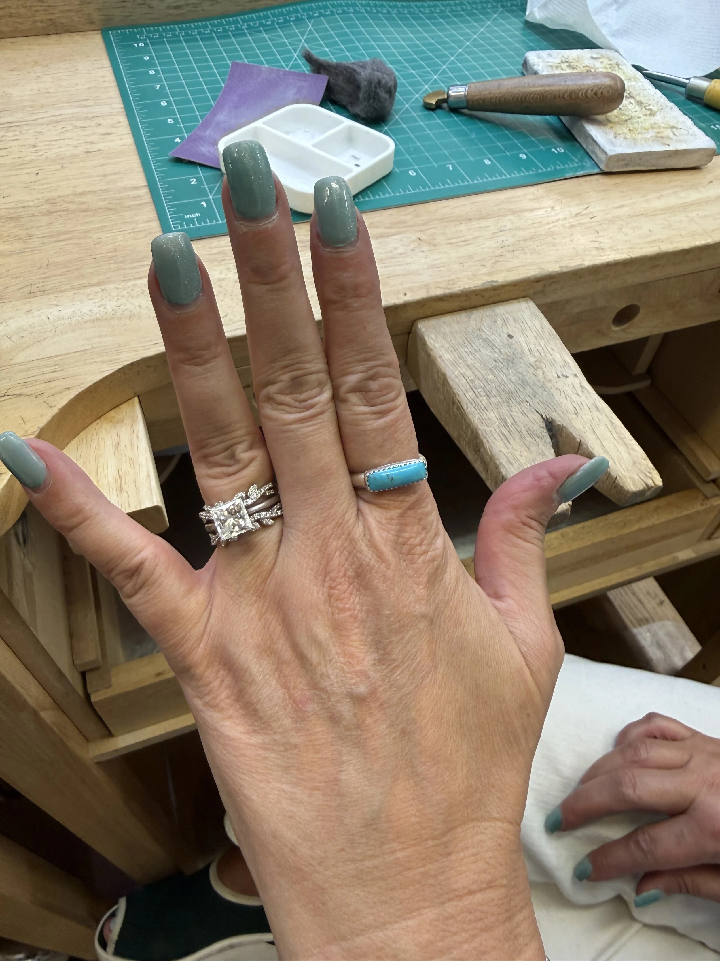 Student trying on a turquoise ring from a Jewelry Making Class in Albuquerque